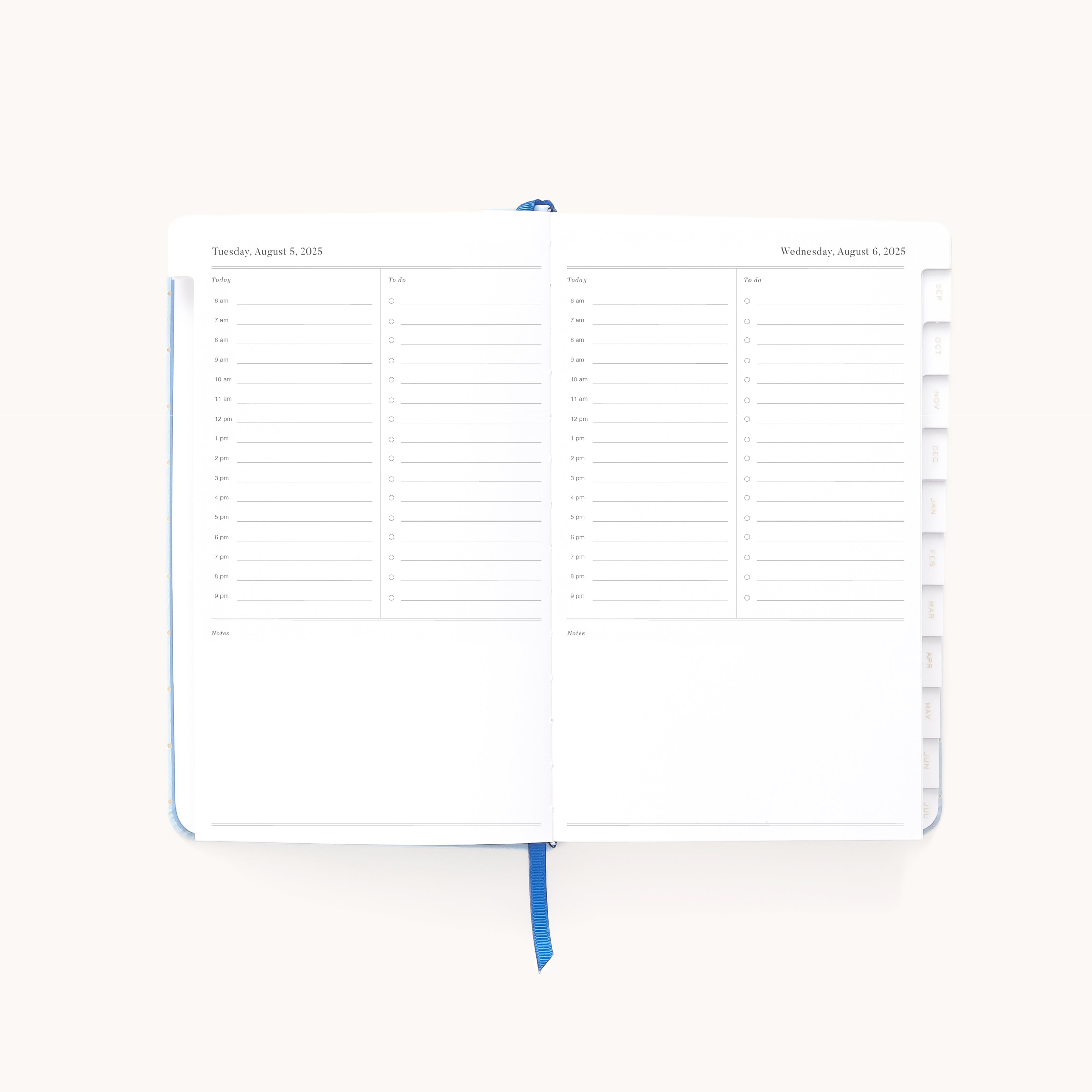 The 2025-2026 Bookbound Daily Dapperdesk Planner - Carolina Dot by Simplified features an elegant leatherette finish. Open to Tuesday, August 5th and Wednesday, August 6th, the planner includes a schedule from 7 a.m. to 8 p.m., a notes section, tabbed dividers and a blue ribbon bookmark in the center.