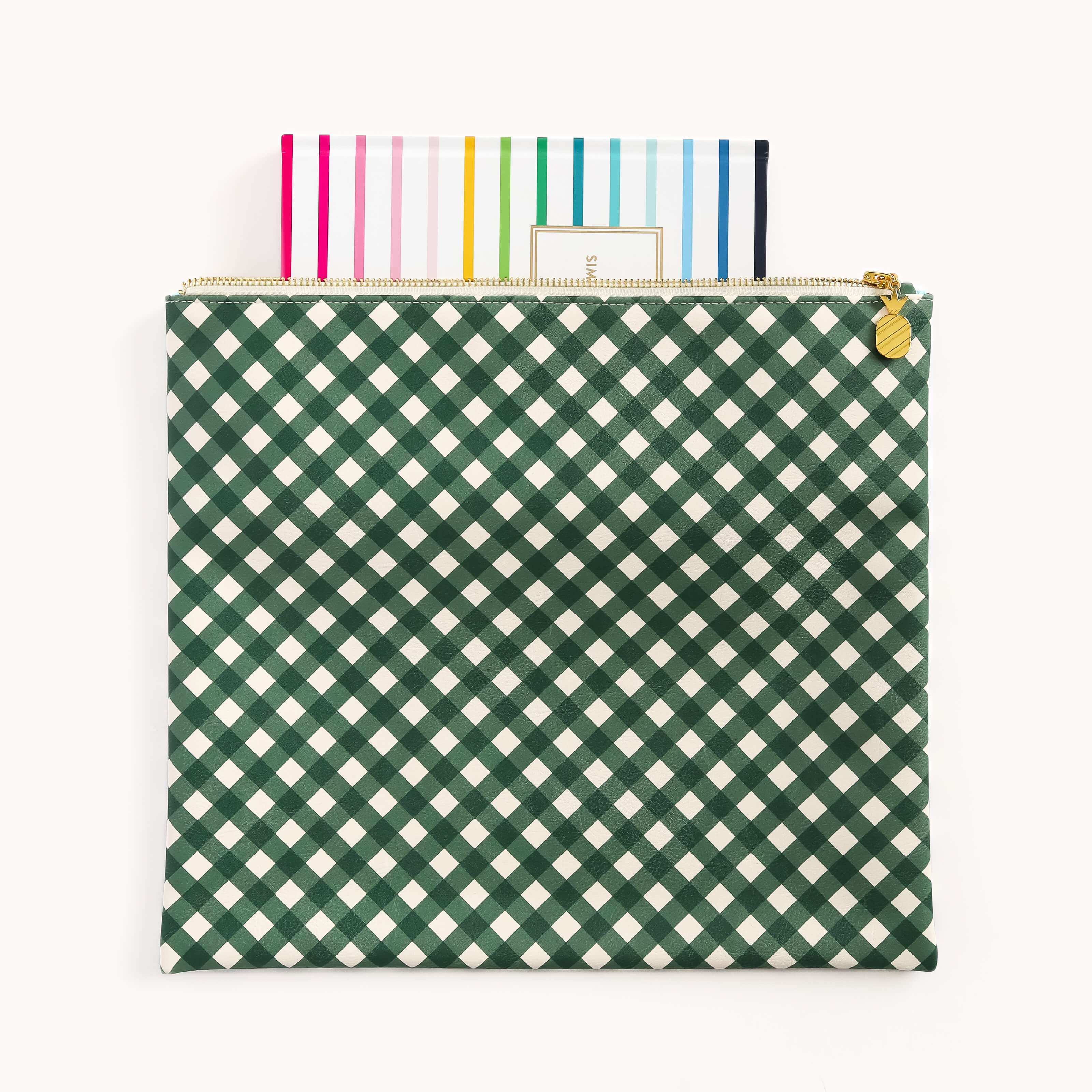 The Planner Pouch - Camp Gingham by Simplified, featuring a green and white checkered design and gold zipper, lies open with colorful striped paper peeking out. Its leatherette exterior enhances the elegance of this chic storage solution.