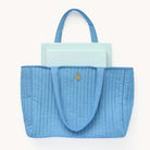 Weekly Dapperdesk Planner and Daily Dapperdesk Planner peeking out from the French Blue Quilted Tote Bag.