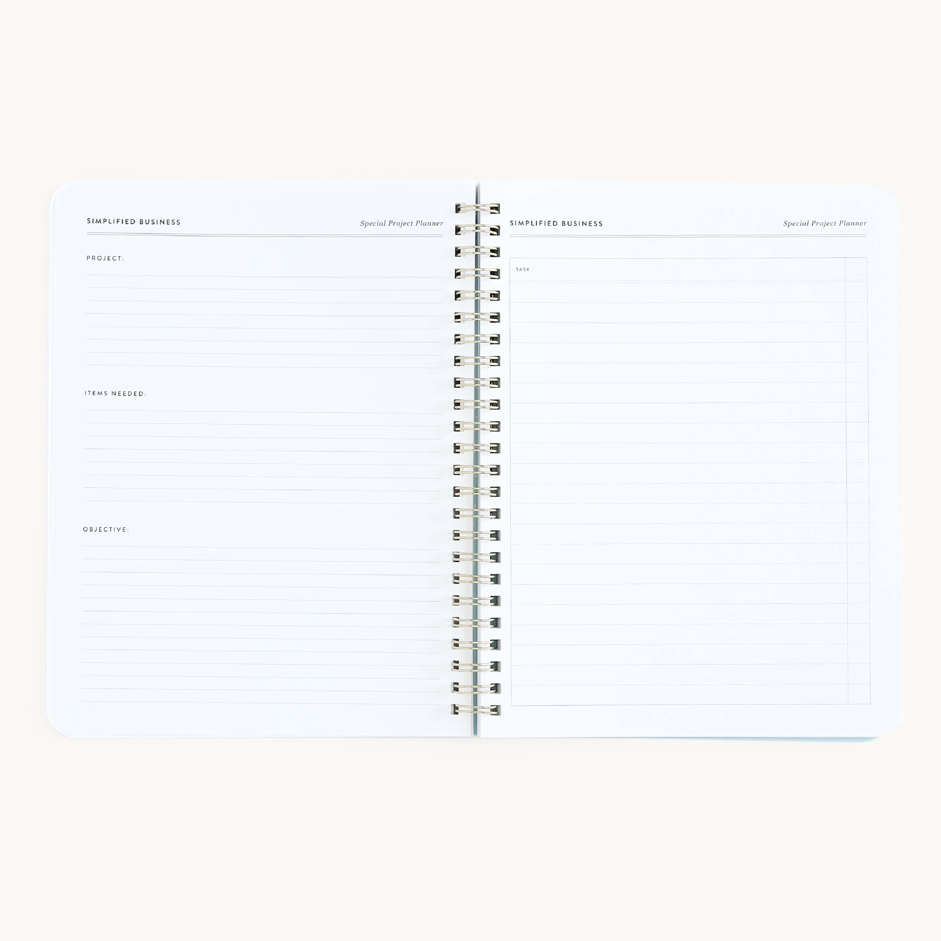 The Simplified Workbook - Entrepreneurship is an open, spiral-bound notebook with sections titled Project, Items Needed, and Objective on the left page, and lined points on the right. Its white, minimalistic design makes it ideal for organizing business ideas effectively.