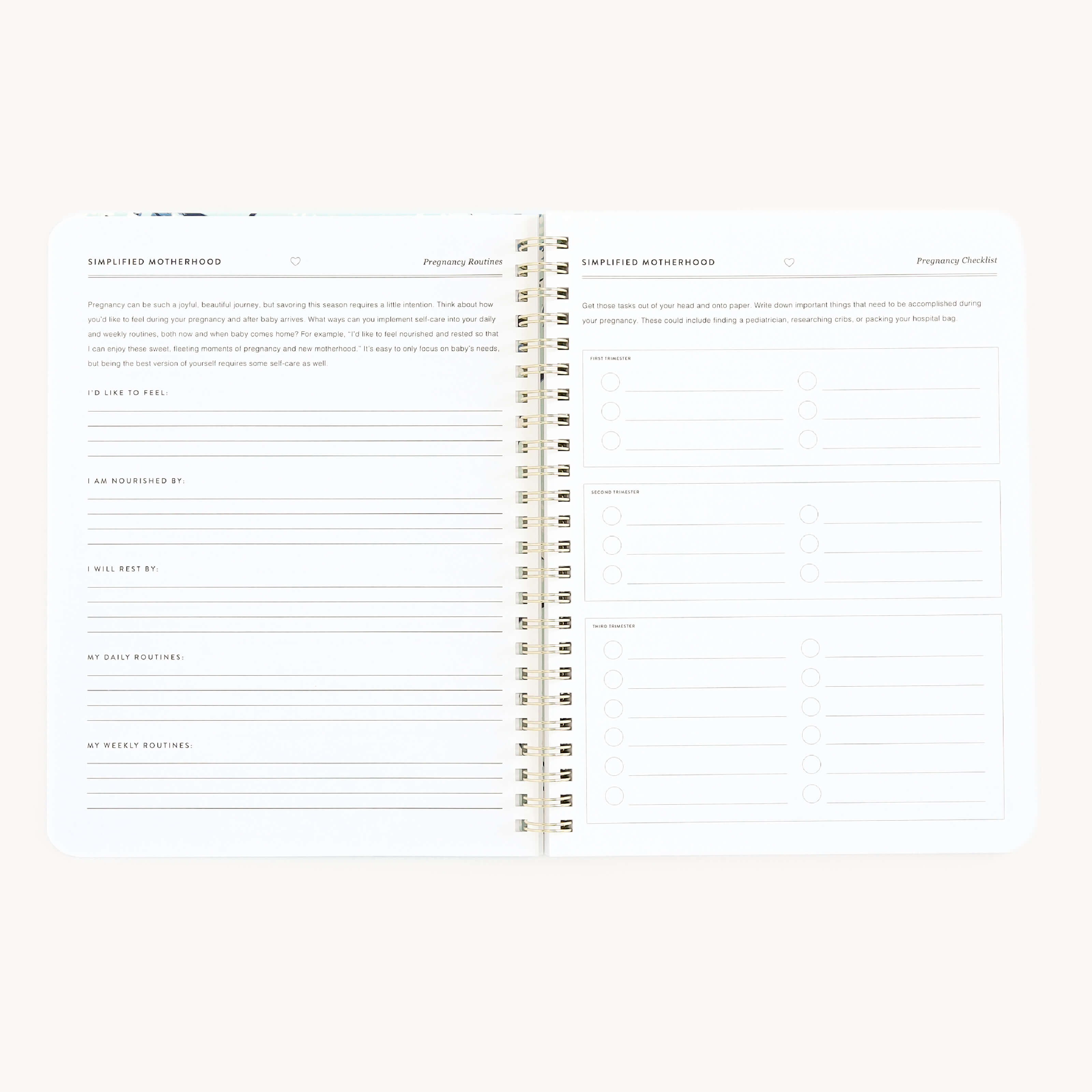The Workbook - New Motherhood by Simplified is a spiral-bound planner with the left page for organizing feelings, nourishment, baby kicks, and routines, while the right page offers checkboxes and notes for essential moms.