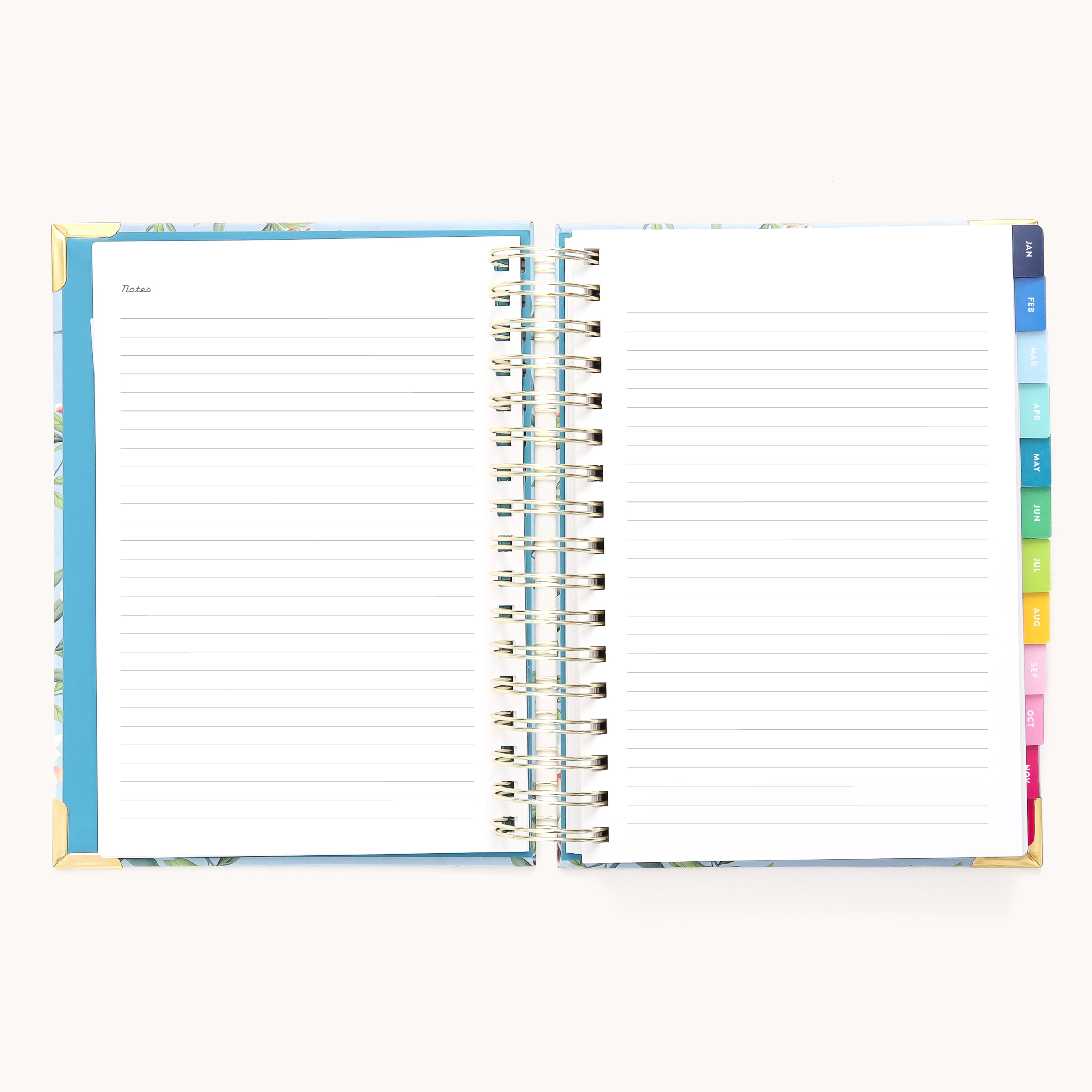 The 2026 Spiral Daily Simplified Planner - Faraway Land by Simplified features an open spiral design with lined pages, gold corner protectors, and colored tab dividers on the right. The left page is labeled Notes, all set against a white background.