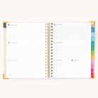 2025 Weekly Simplified Planner by Emily Ley in the Blush Block cover design open to a two-page weekly spread. Features a clean, minimalistic design with lined sections for daily tasks, to-do lists, and notes. Includes color-coded weekday labels, durable spiral binding, and gold corner protectors.