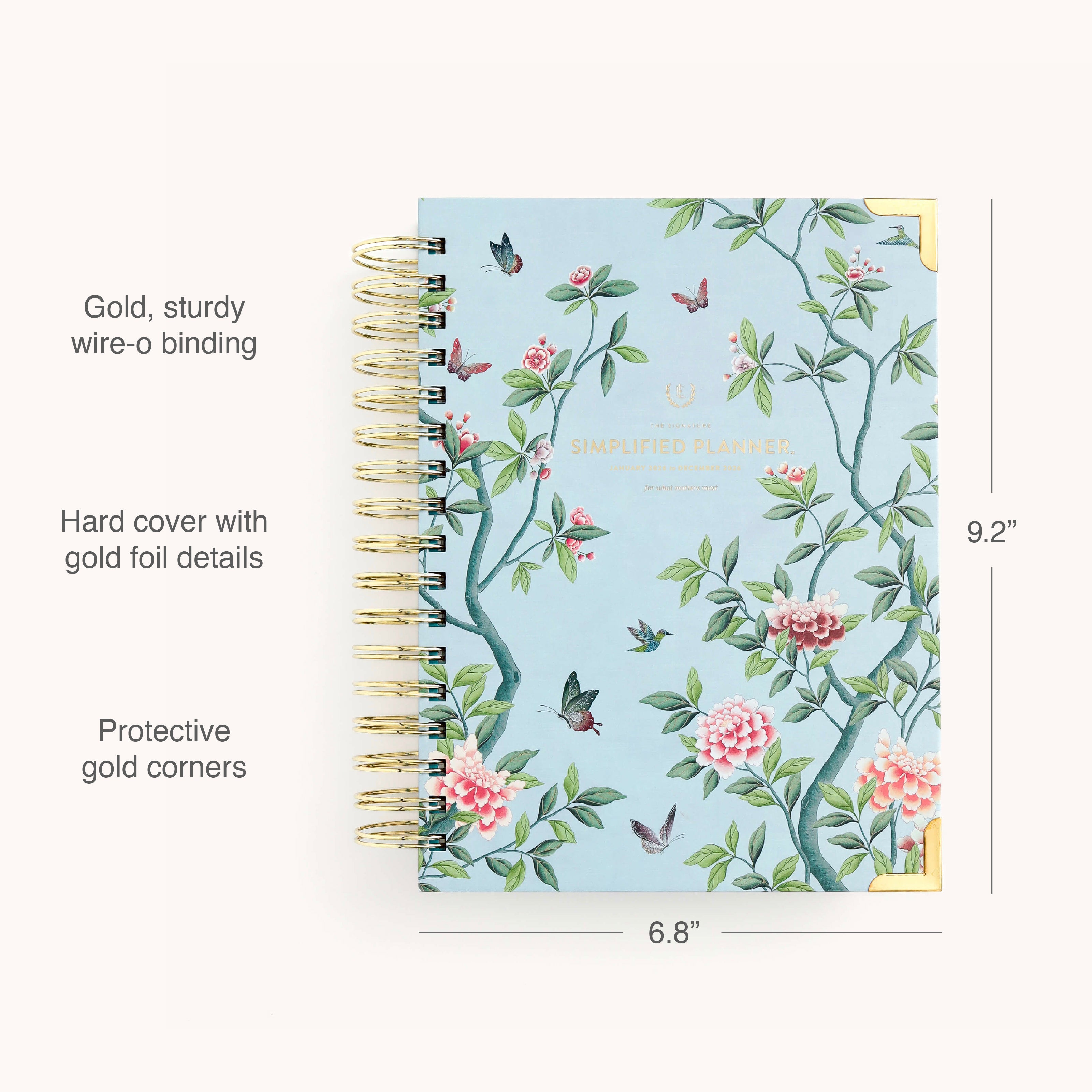 The 2026 Spiral Daily Simplified Planner - Faraway Land by Simplified features a hand-painted floral cover, gold wire-o binding, gold foil accents, protective gold corners, and measures 9.2 x 6.8.