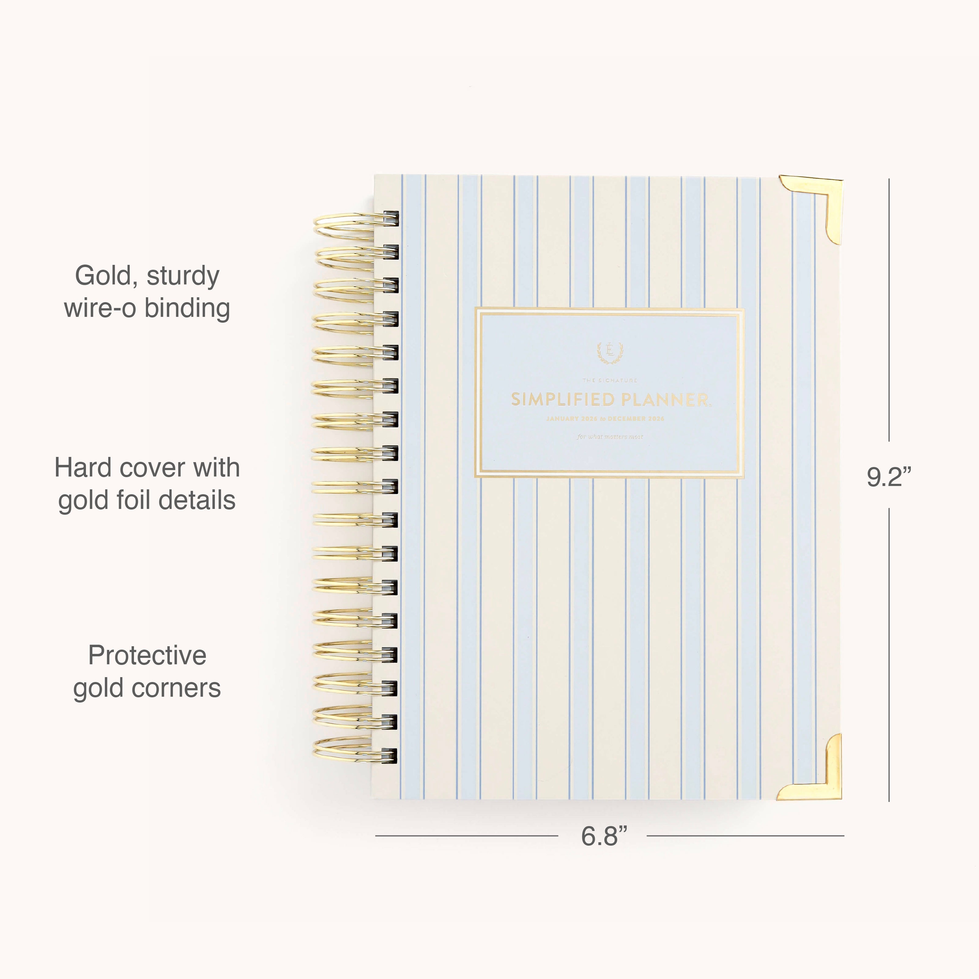 The Simplified 2026 Spiral Daily Simplified Planner - Serene Stripe features a striped hardcover, gold wire-o binding, protective gold corners, a centered “Daily Simplified Planner” label, elegant gold foil details, and measures 9.2 x 6.8.