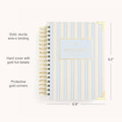 The Simplified 2026 Spiral Daily Simplified Planner - Serene Stripe features a striped hardcover, gold wire-o binding, protective gold corners, a centered “Daily Simplified Planner” label, elegant gold foil details, and measures 9.2 x 6.8.