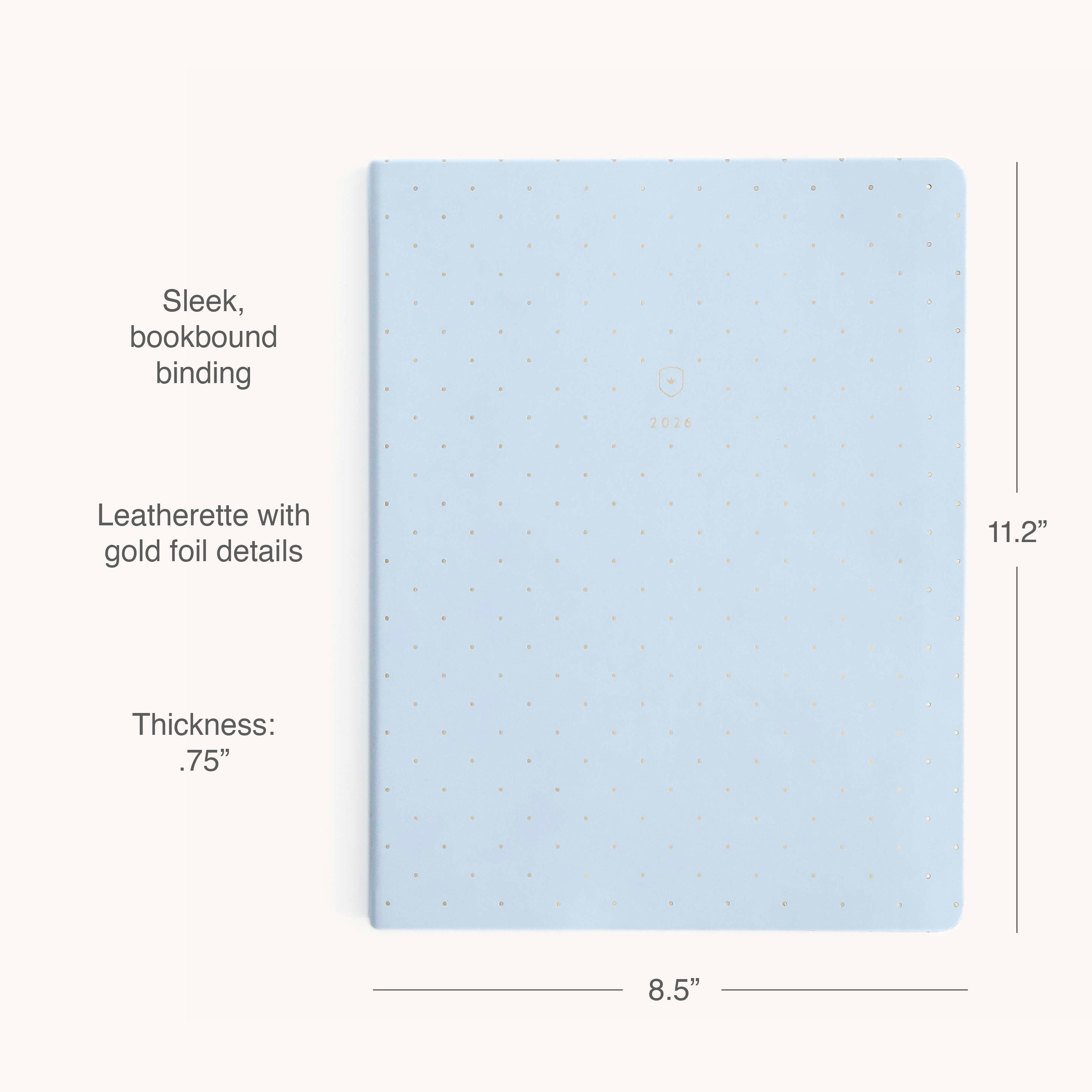 The Simplified 2026 Bookbound Weekly Dapperdesk Planner - Carolina Dot features a pale blue leatherette cover with gold foil dots, “2026” embossed at center, sleek bookbound binding, and measures 11.2 x 8.5 x 0.75.