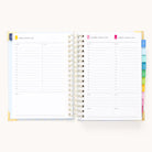 The 2025-2026 Spiral Daily Simplified Planner - Serene Stripe by Simplified lays open, displaying a spiral-bound page for Friday, August 11, 2023, with gold foil details. It includes sections for notes and to-do lists, and color-coded tabs on the right distinguish each month.