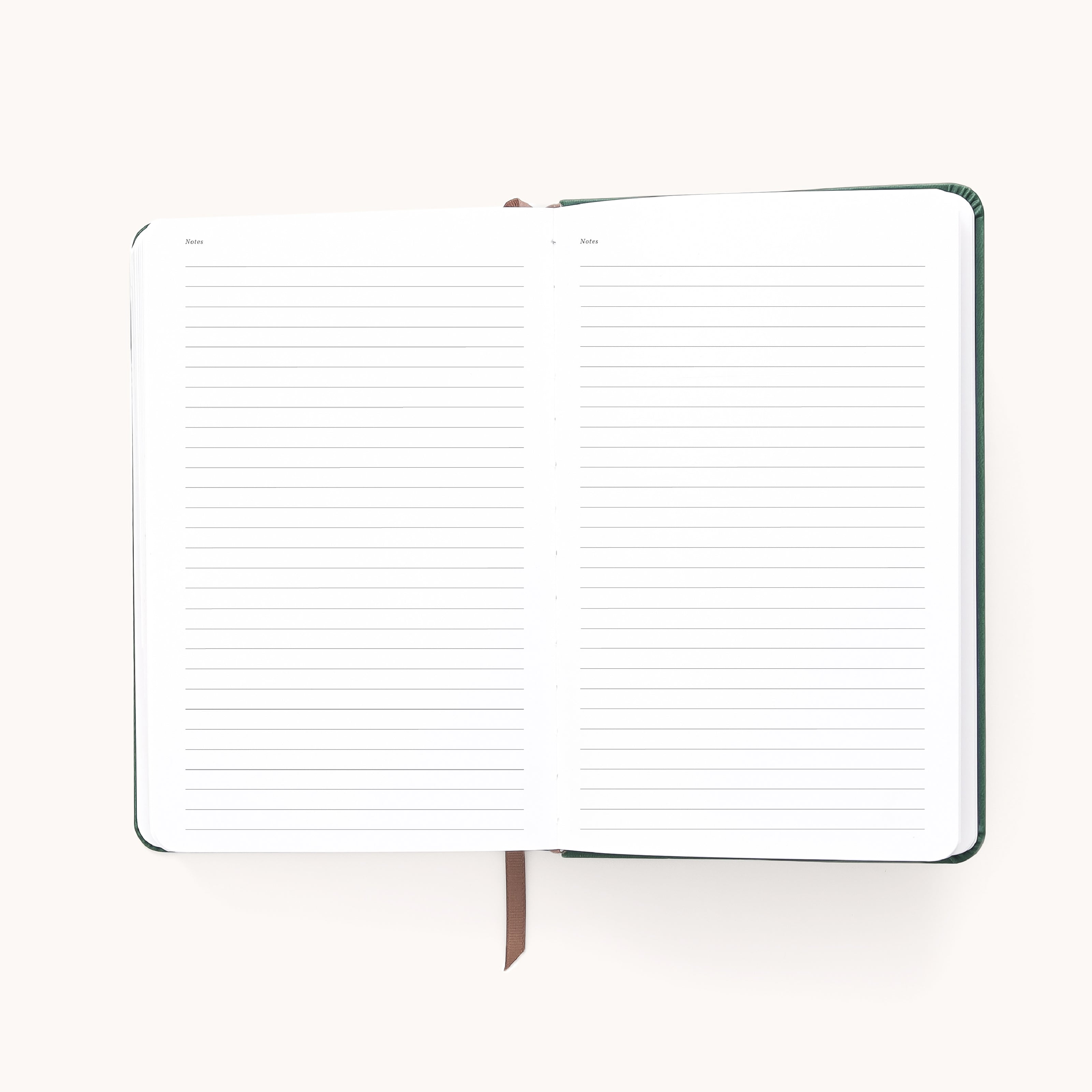 The 2026 Bookbound Daily Dapperdesk Planner by Simplified features a stylish evergreen leatherette cover, open lined pages, and a brown ribbon bookmark—perfect for organizing your year in style.