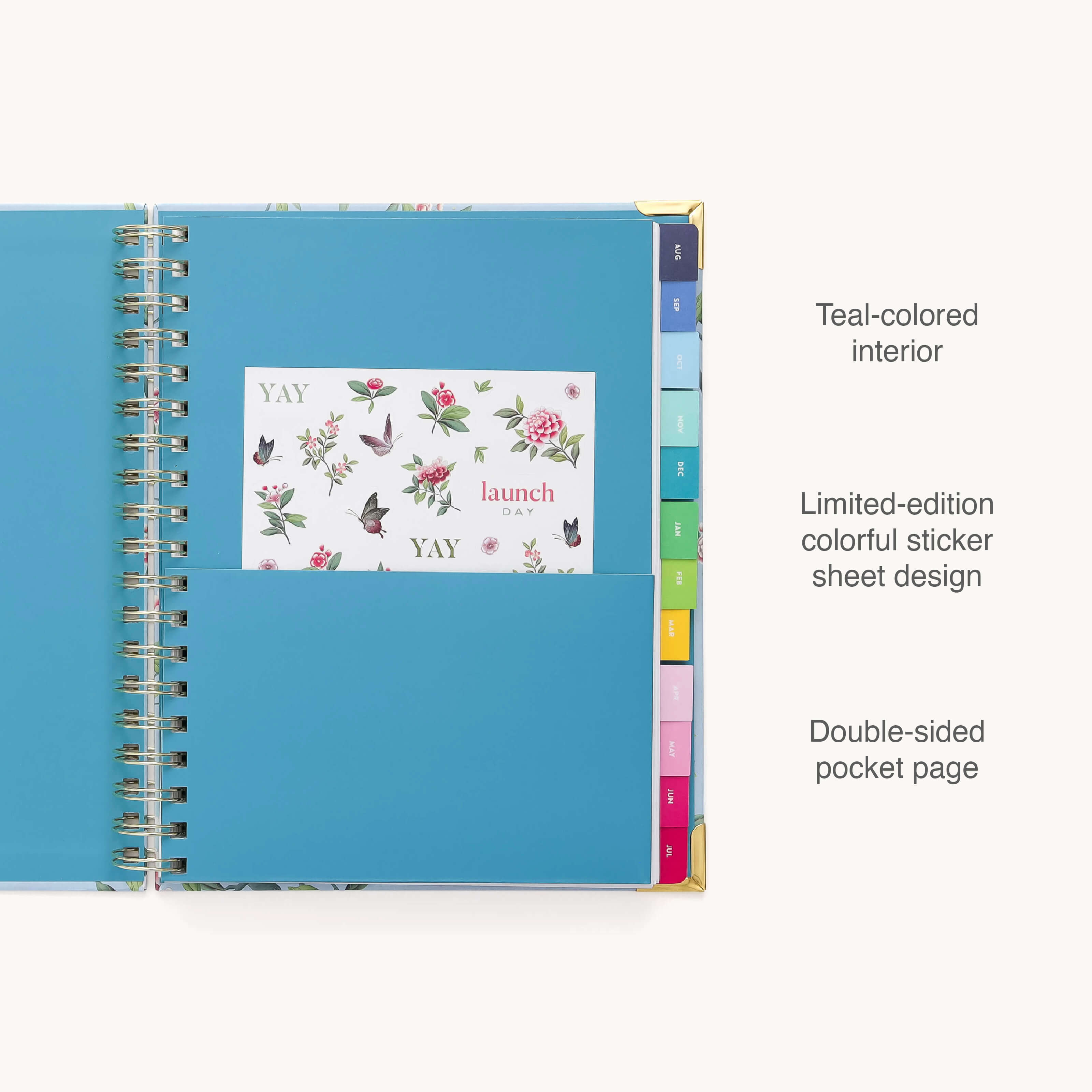 The 2025-2026 Spiral Weekly Simplified Planner - Faraway Land by Simplified features a blue cover with a floral edge and gold foil accents. Inside, a YAY note card peeks from a pocket, while colorful tabs on the right divide sections for efficient planning.