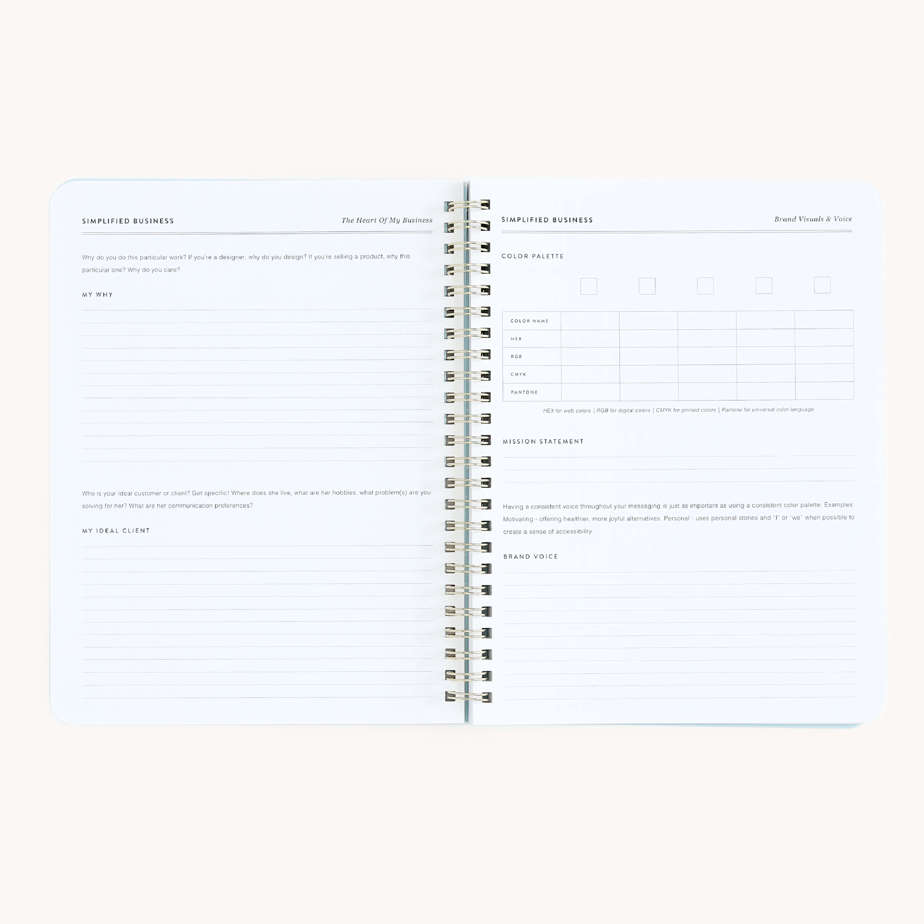 Simplifieds Workbook - Entrepreneurship, an open spiral-bound notebook on a light background, awaits your next big business idea. It includes structured sections like My Why and My Ideal Client, with writing lines and small checkboxes for detailing concepts.