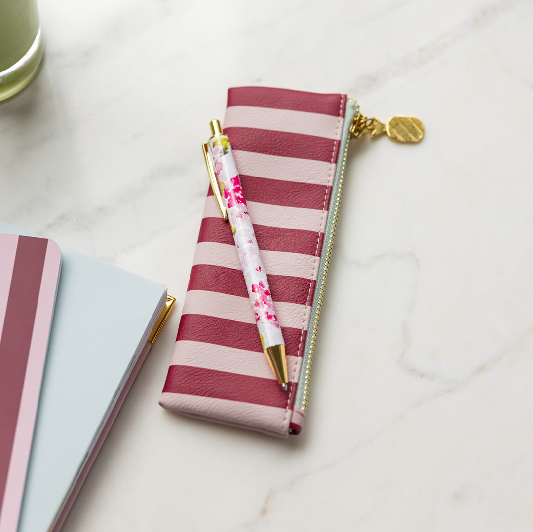 Berry Stripe Petite Pen Case styled on desk with pen on top