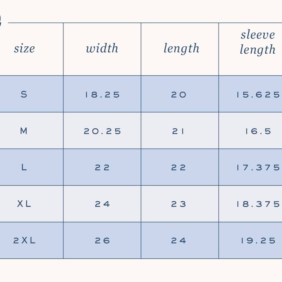 The Simplified Boxy T-Shirt - The Best That Could Happen features a size chart (S-2XL) with width, length, and sleeve measurements on alternating white/blue rows and a wreath logo, all made from 100% cotton.