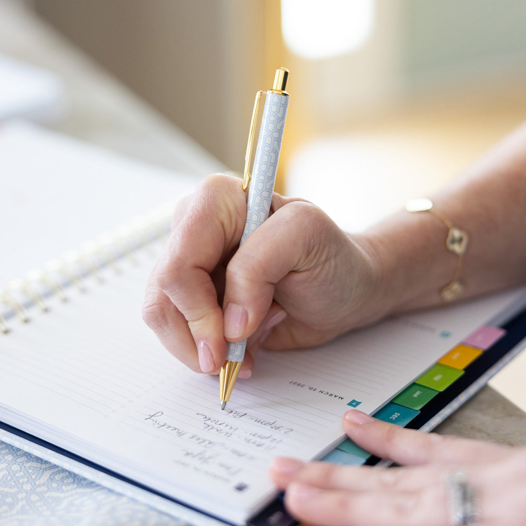 Carolina Trellis pen held in hand while writing at desk, featuring classic pattern and gold clip for a polished everyday writing experience