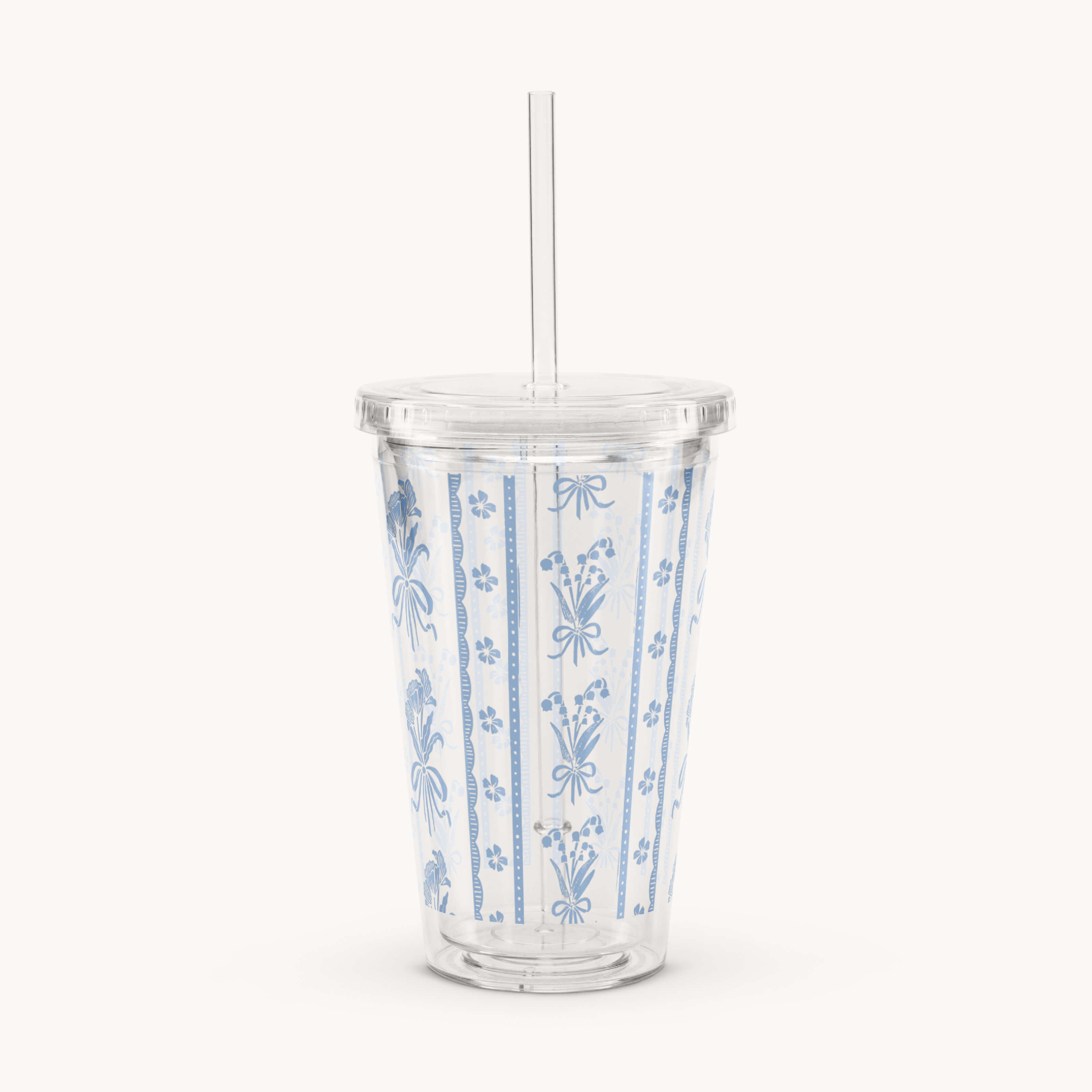 The Simplified Clear Tumbler - Poppy Posies features blue and white stripes with floral motifs tied with bows. Insulated and reusable, it comes with a lid and straw, perfect for enjoying your drinks on the go.