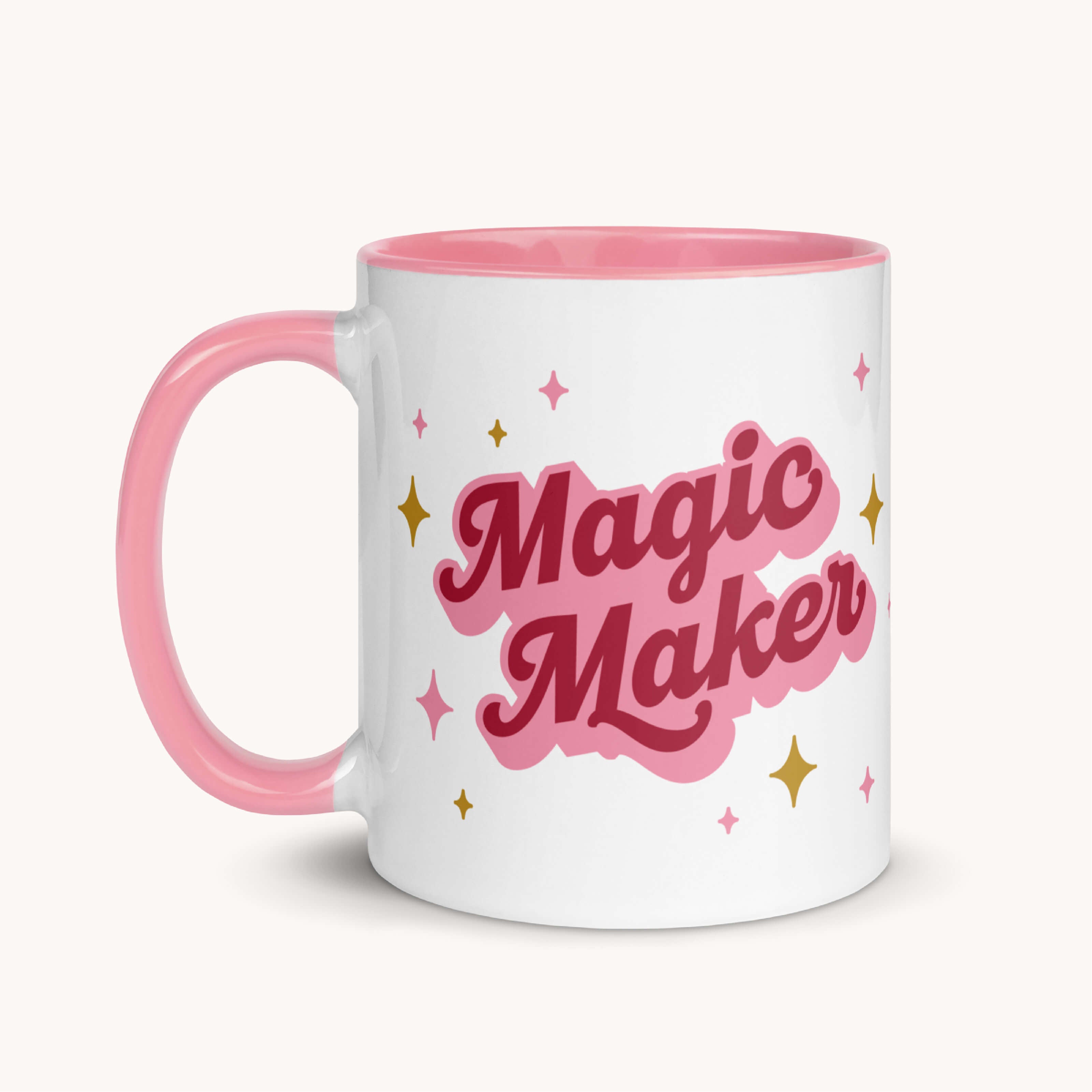 The Simplified Mug - Magic Maker is an 11 oz ceramic mug with a pink handle and interior, bold “Magic Maker” text, yellow star accents, and is microwave safe—perfect for your favorite drinks.