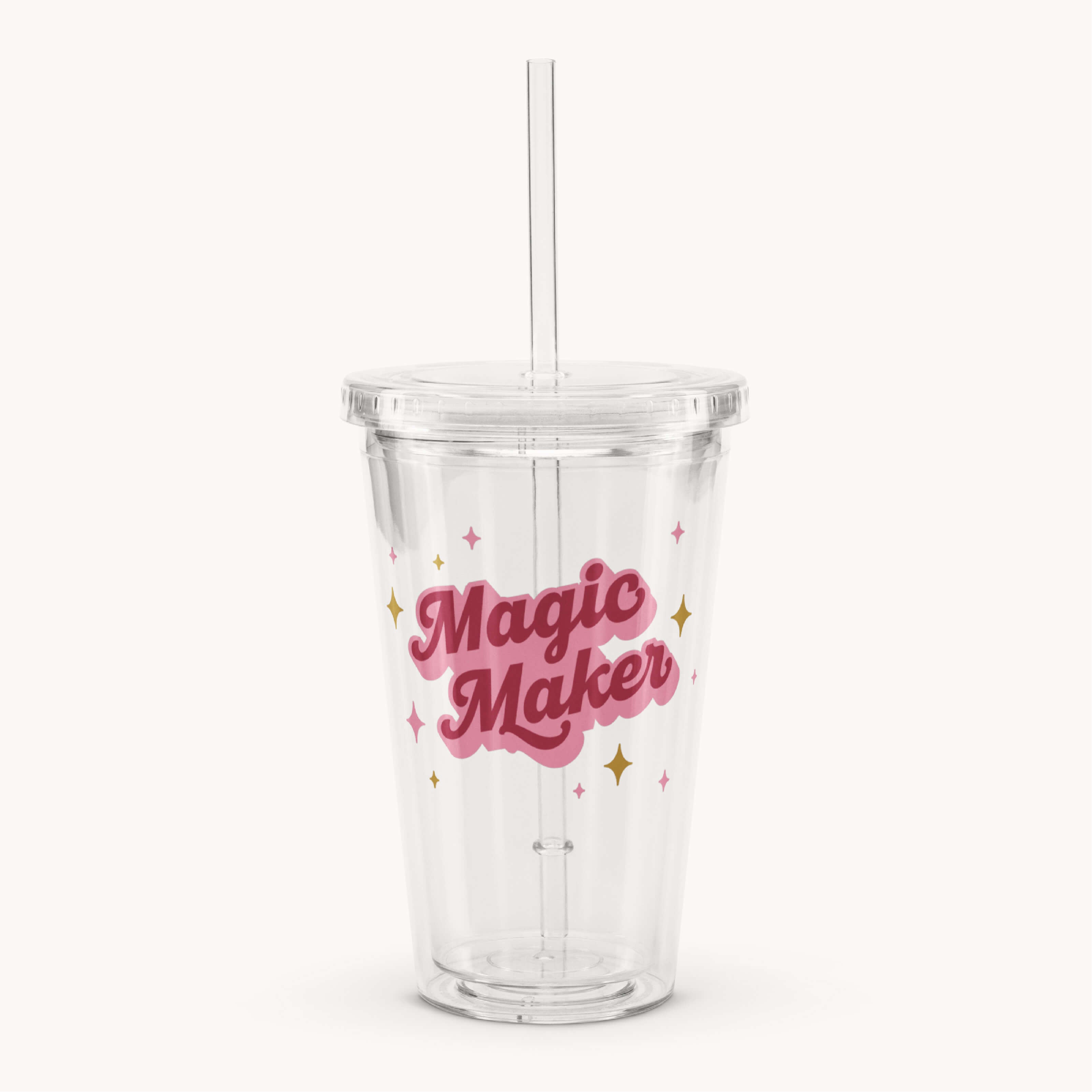 The Simplified Clear Tumbler - Magic Maker is a 16oz reusable cup with a lid and straw, featuring “Magic Maker” in pink lettering and colorful stars—perfect for enjoying your favorite drinks.