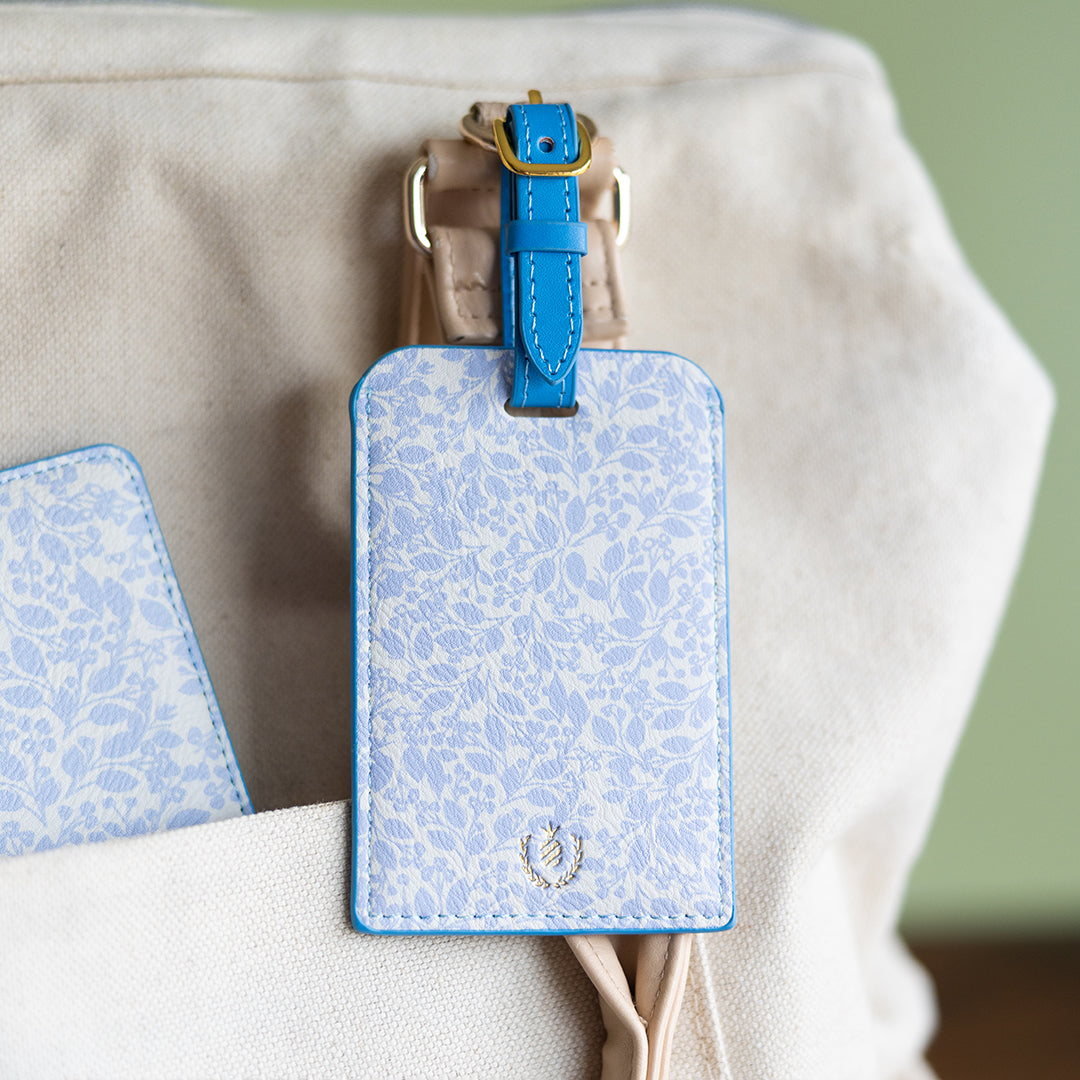 Misty Meadow floral luggage tag attached to travel bag by Simplified by Emily Ley