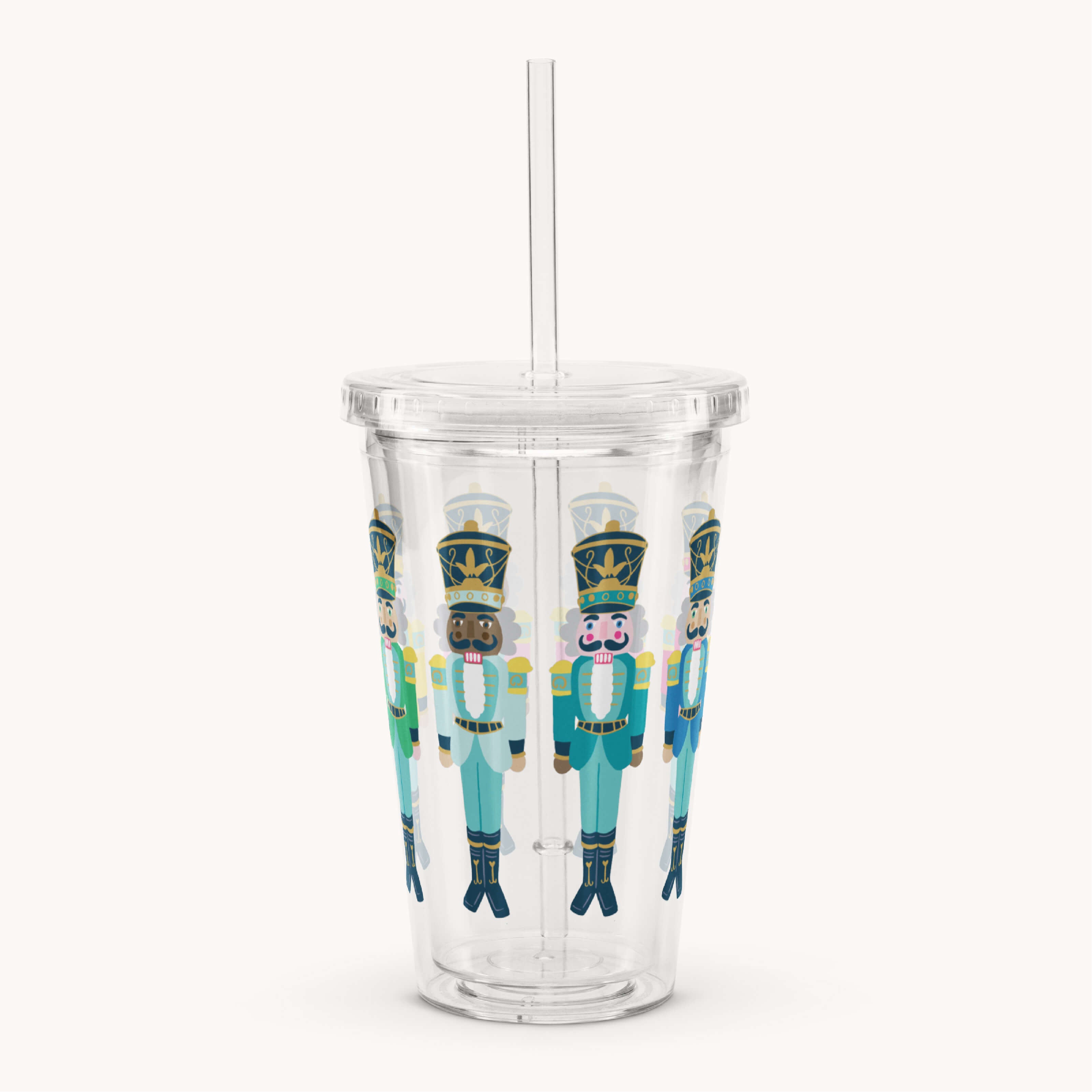 The Simplified Clear Tumbler - Nutcrackers is a 16oz insulated cup with lid and straw, featuring blue-uniformed nutcracker soldiers—perfect for enjoying your favorite drinks in style.