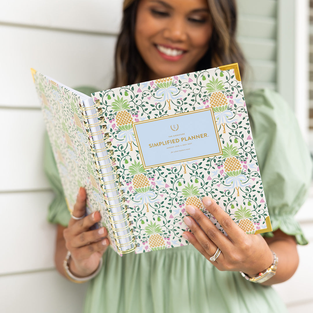 Woman holding spiral weekly planner