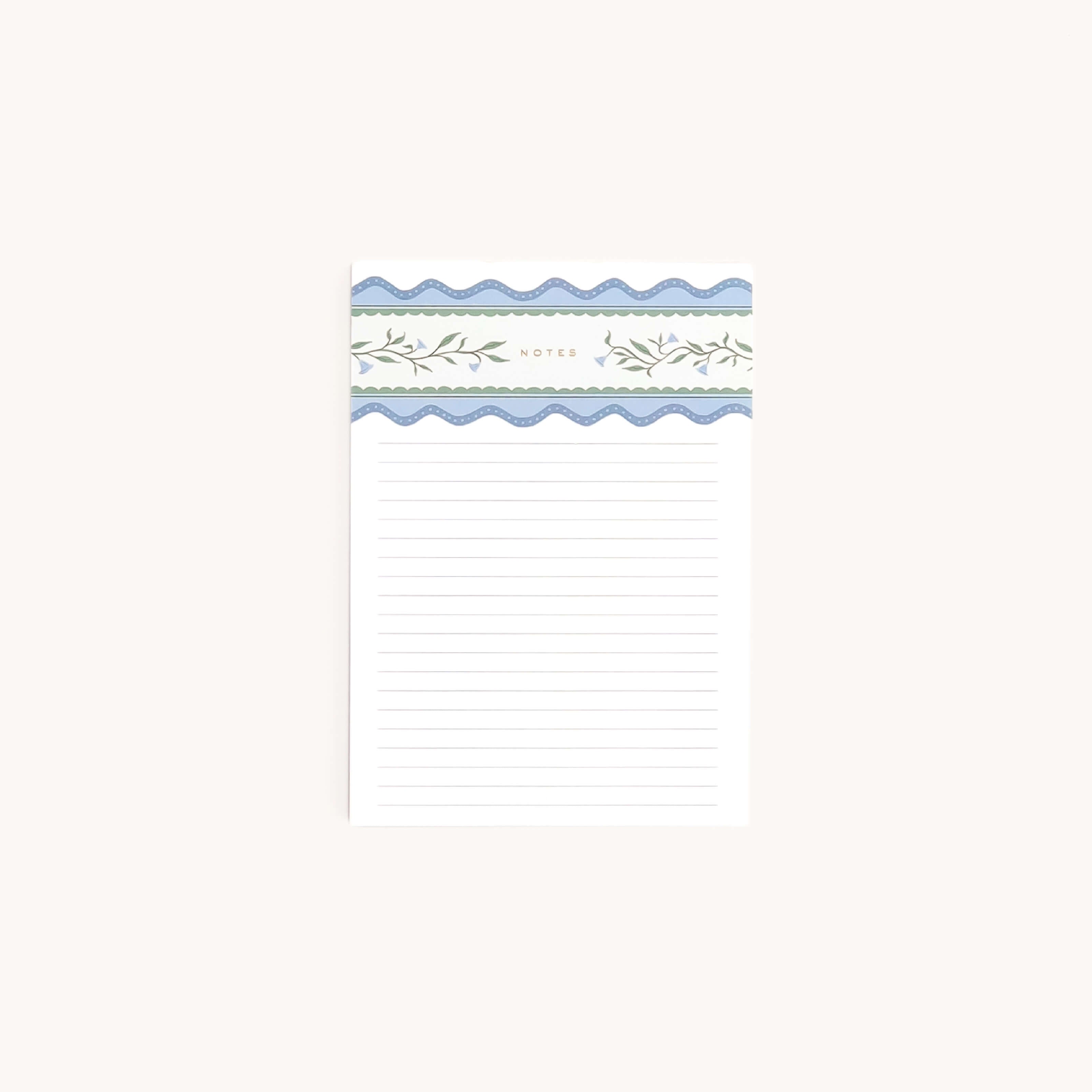 Notepad with decorative top margin on a white background