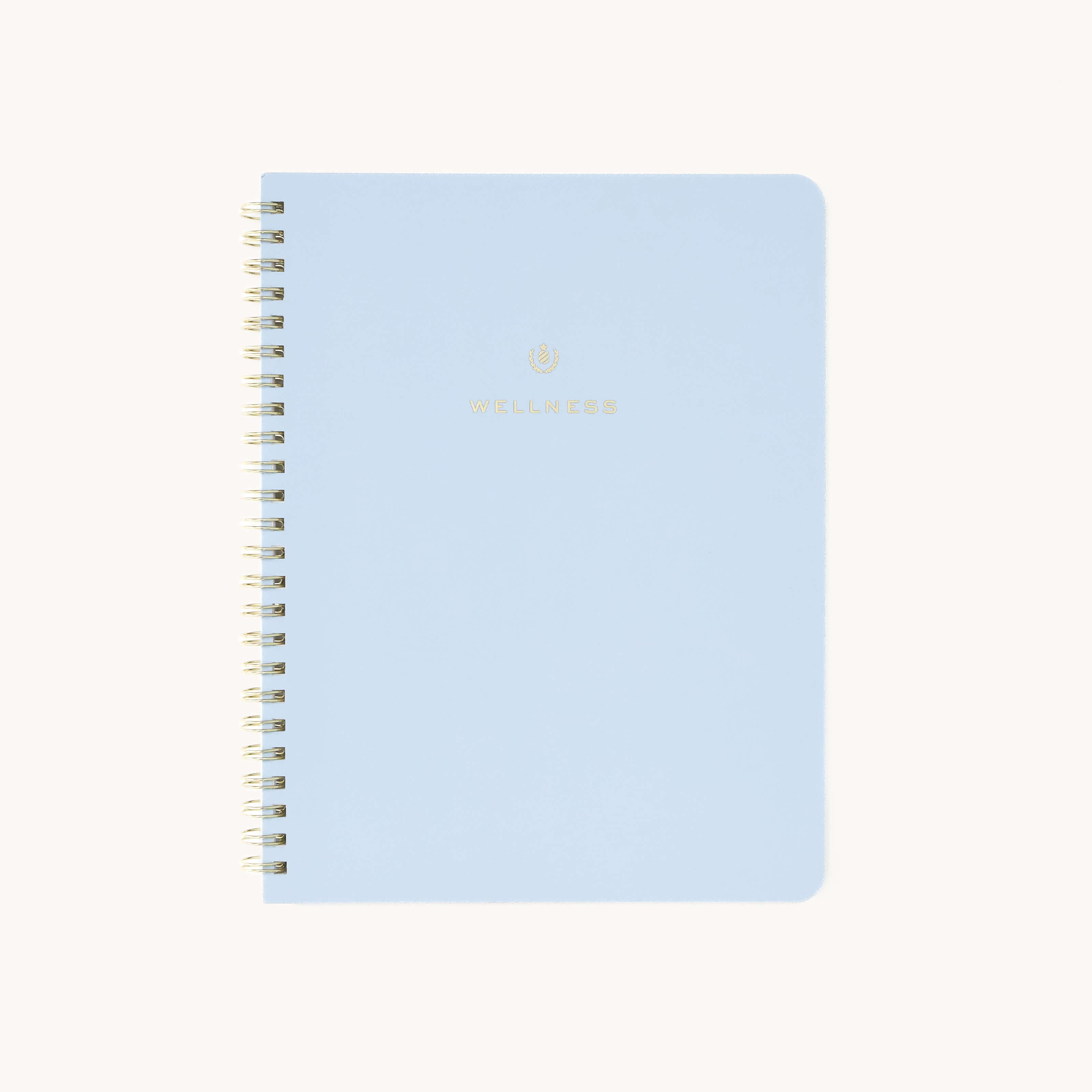 A light blue spiral-bound wellness workbook titled Wellness features gold and the brand Simplified in smaller gold caps at the bottom—ideal for tracking goals and embracing self-care.
