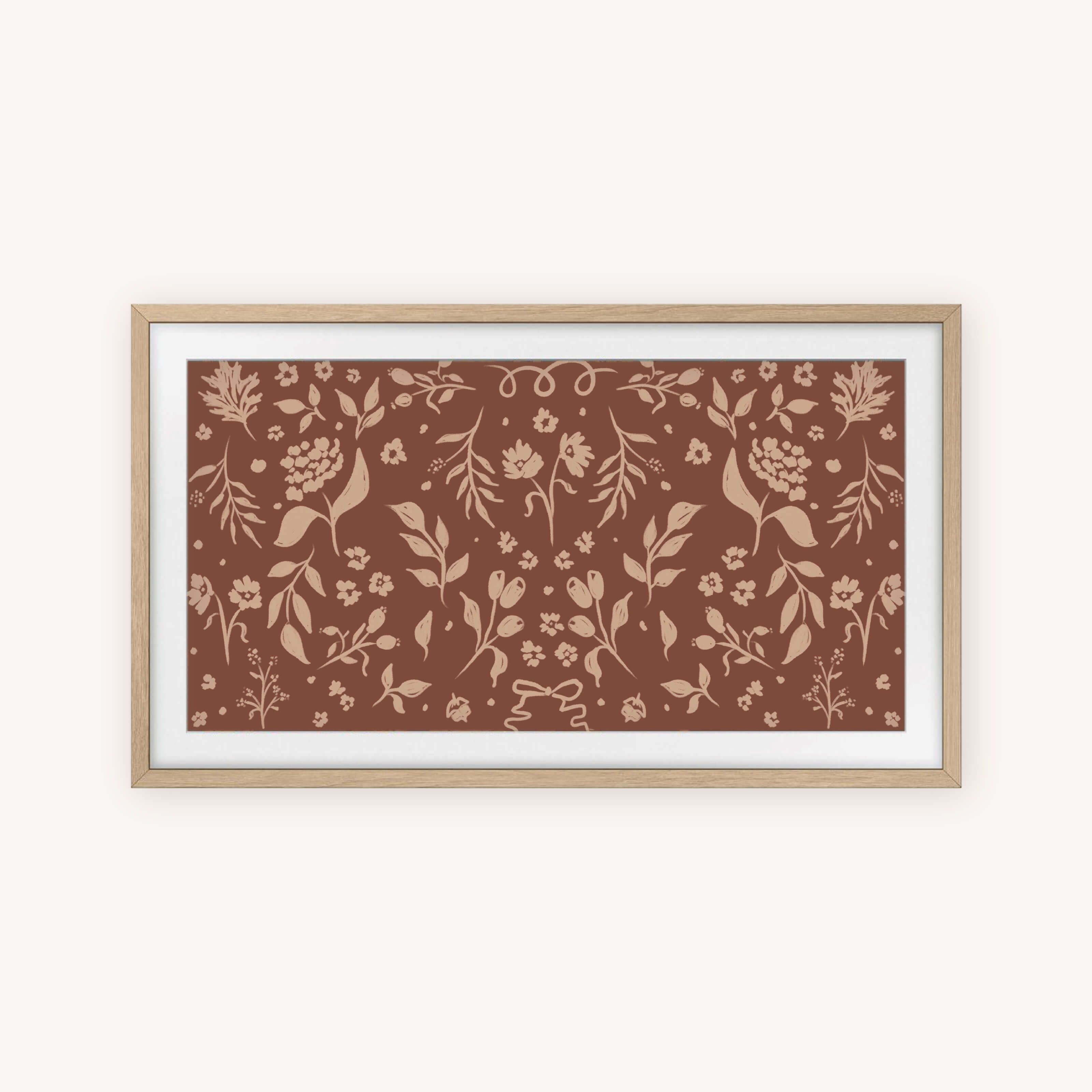 The "Frame TV Art - Fall Blooms" by Simplified features a brown background with symmetrical light tan botanical designs. A light wood frame and white mat complete this elegant piece, perfect for enhancing your space.