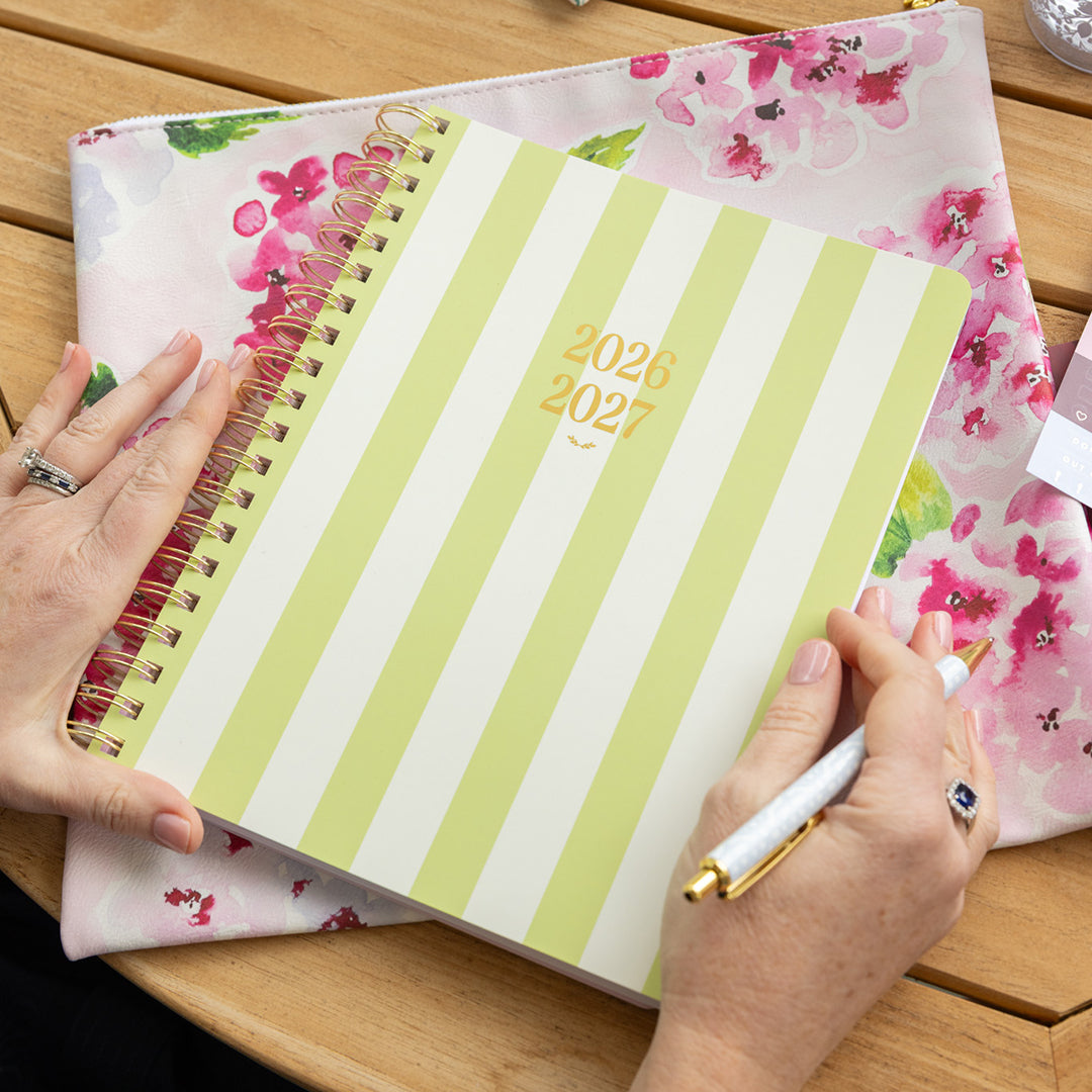 Large softcover weekly planner styled in an elegant workspace for simple, cheerful weekly planning