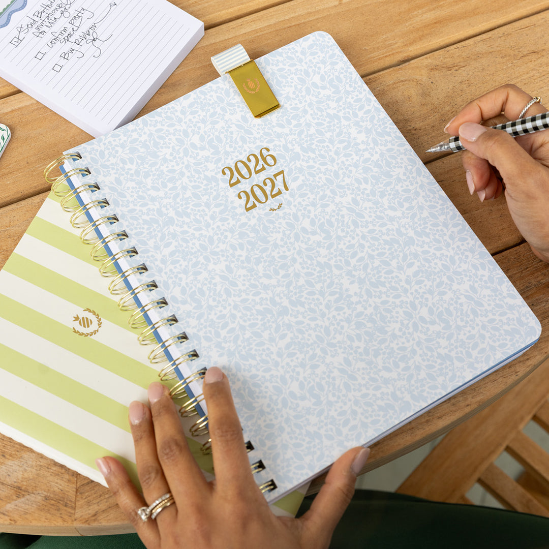 Large softcover weekly planner styled in an elegant workspace for simple, cheerful weekly planning