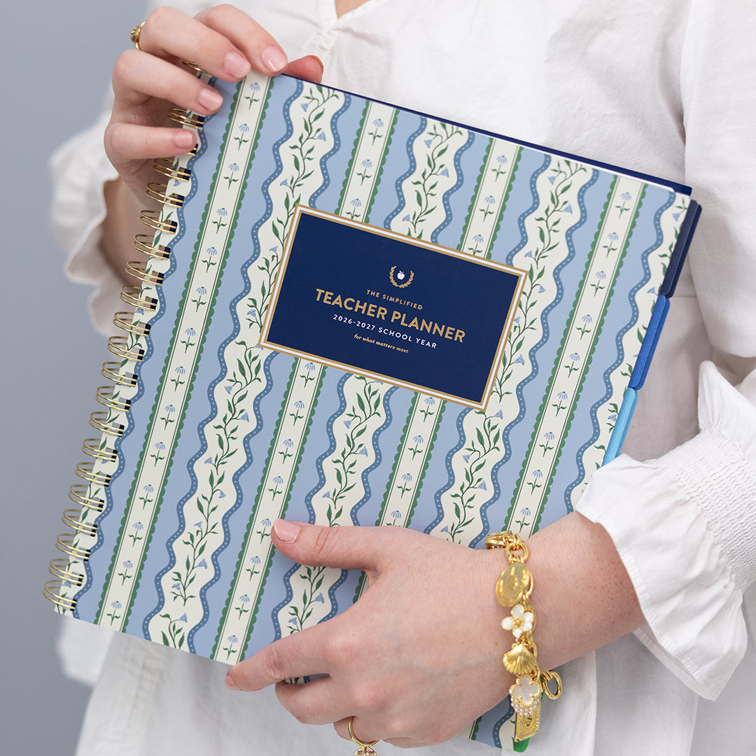 Floral Stripe teacher planner held in hands with elegant striped cover and gold accents for stylish, organized teaching
