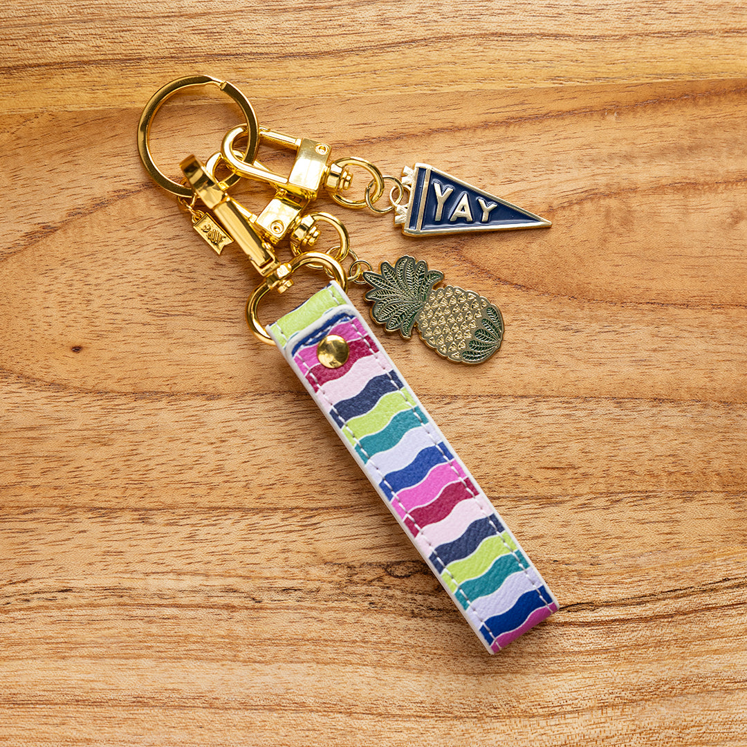 Rainbow Row leatherette key chain attached to keys and charms with gold hardware by Simplified by Emily Ley