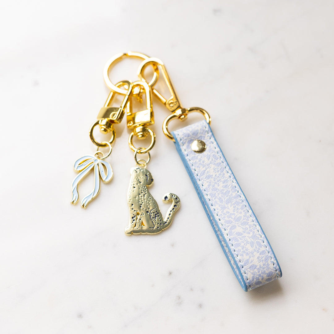 Misty Meadow leatherette key chain attached to keys and charms with gold hardware by Simplified by Emily Ley