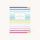The 2026 Bookbound Weekly Simplified Planner - Happy Stripe by Simplified features horizontal pastel and bold stripes, gold corners, lay-flat binding, a centered Simplified Planner label, and an off-white background for a timeless look.