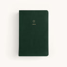 The Simplified 2026 Bookbound Daily Dapperdesk Planner in Evergreen features a leatherette cover, rounded corners, a small gold emblem, and 2026 in gold on the front, shown against a plain white background.