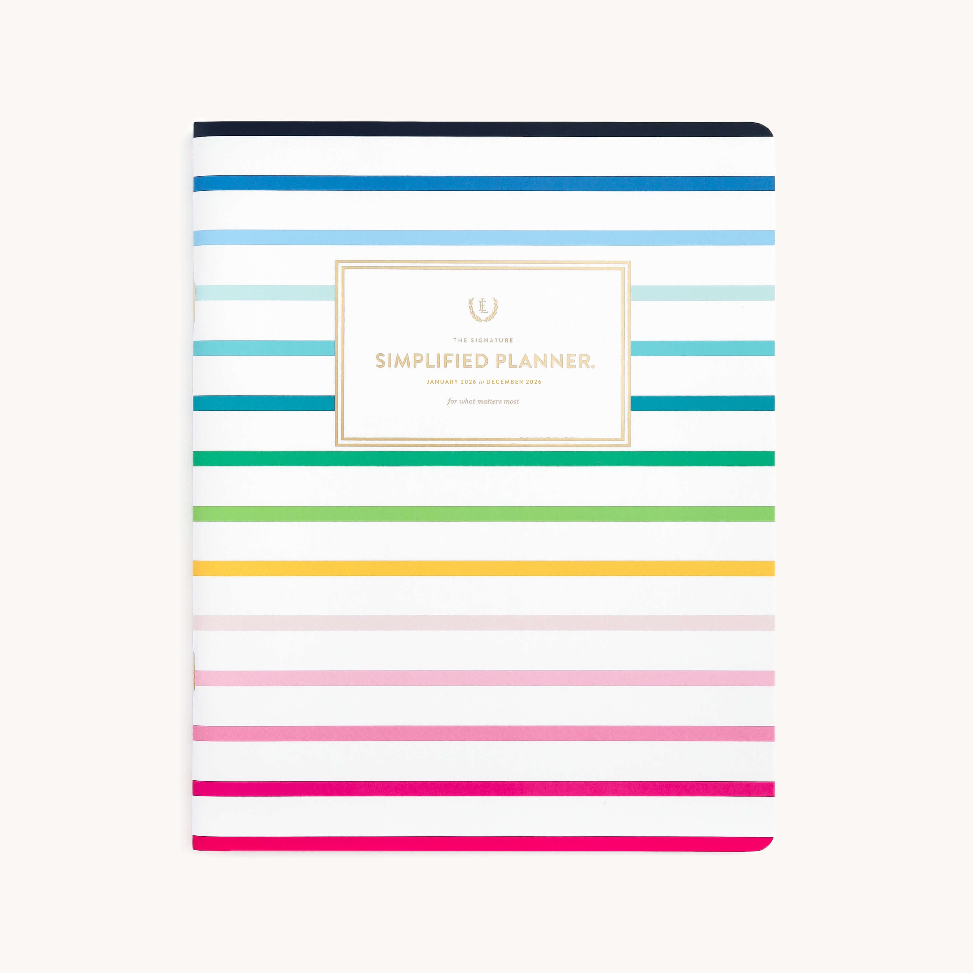 Front cover of the 2026 Softcover Monthly Simplified Planner - Happy Stripe by Simplified, featuring horizontal blue, green, yellow, pink, and red stripes. A center white label reads Simplified Planner in gold—bright and stylish organization.