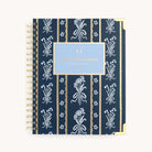 The 2026 Spiral Weekly Simplified Planner - Poppy Posies by Simplified features a navy cover with white floral and stripe patterns, gold corners, and a central blue label—a stylish choice for your 2026 planner.