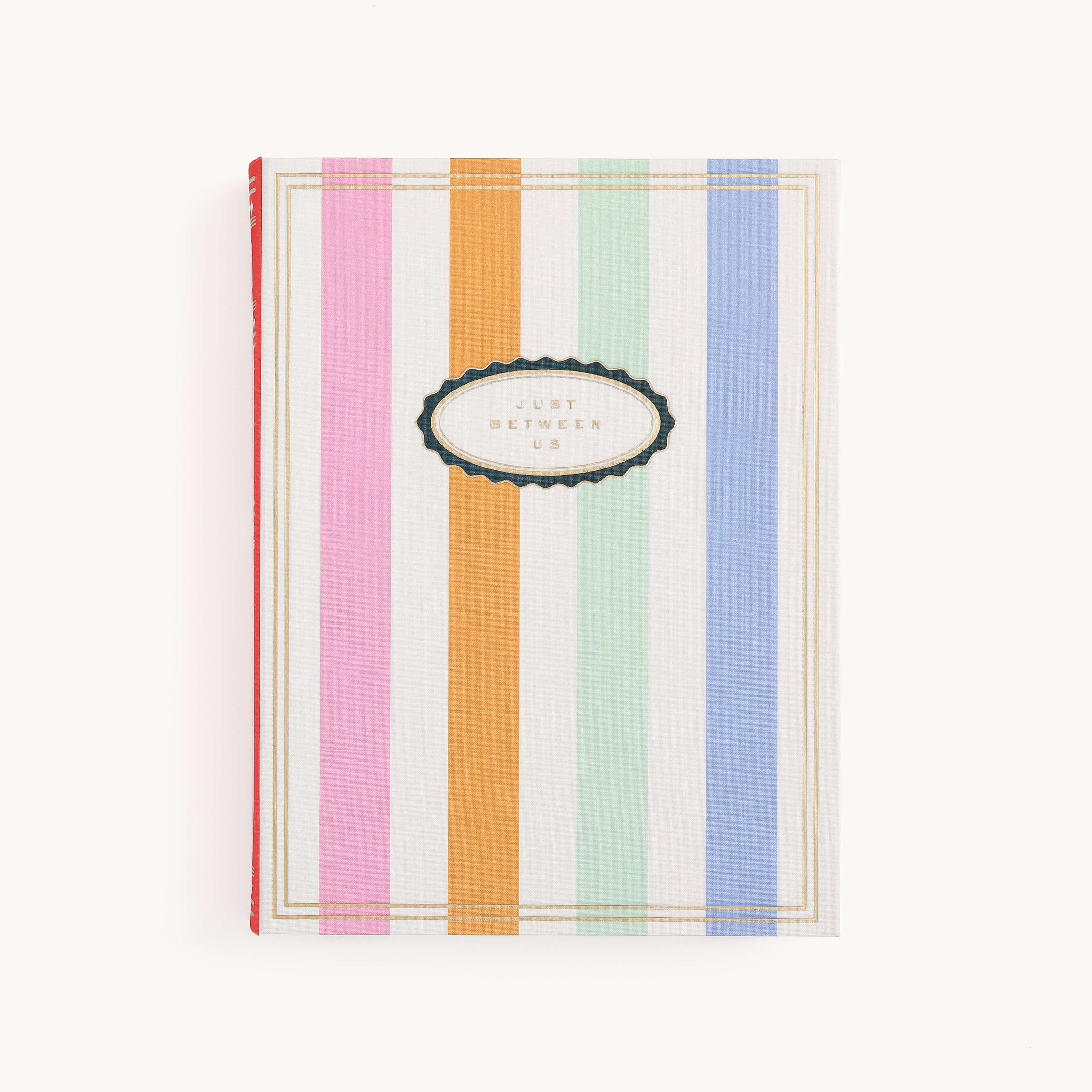 The Simplified Linen Journal - Back and Forth features a hardcover with vertical pastel stripes in pink, green, orange, blue, and white, and a black-edged white oval with gold trim reading Just Between Us in uppercase letters.