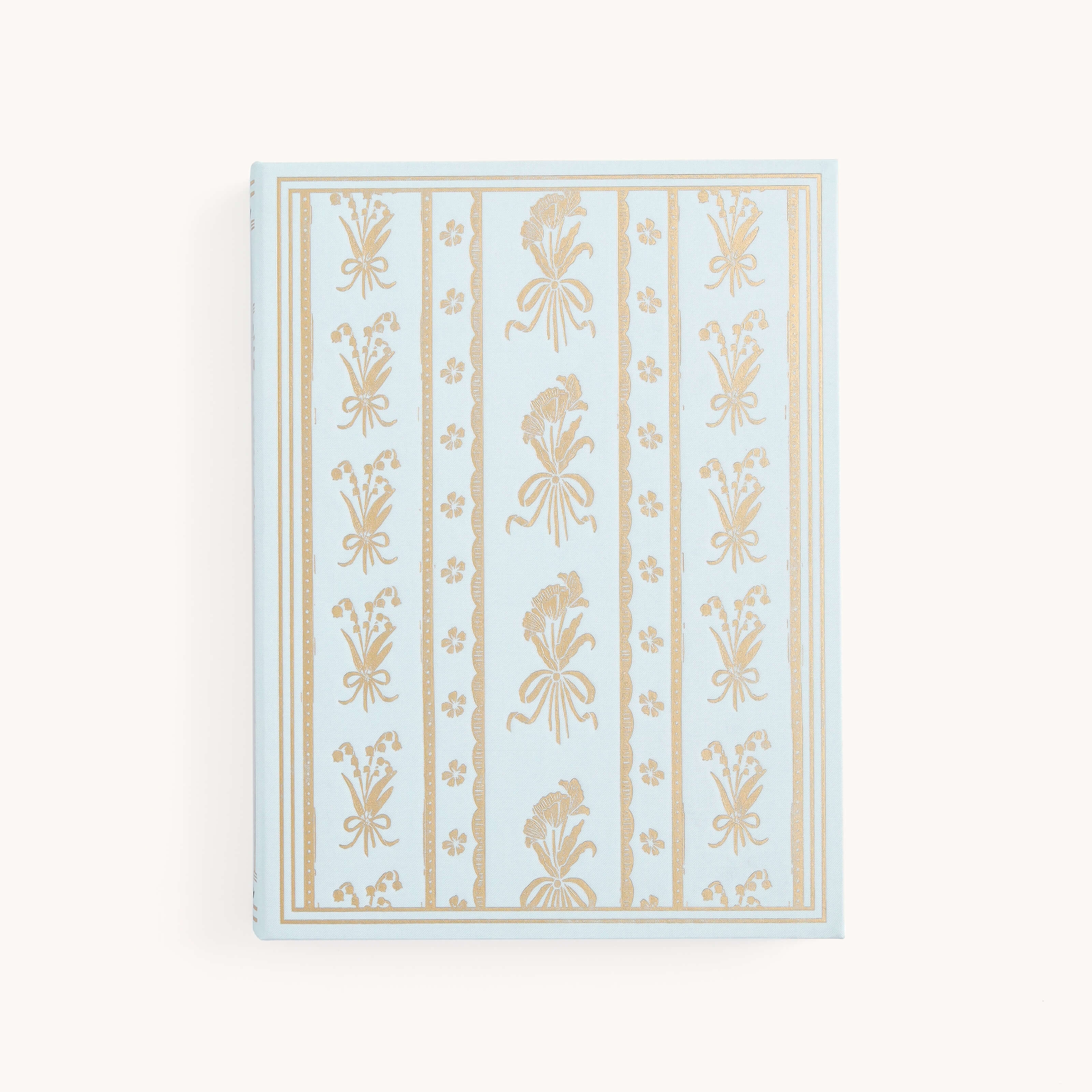 The Simplified Linen Journal - Block Floral features a light blue linen hardcover with an ornate, hand-drawn gold floral and geometric design on the front, displayed against a plain white background.