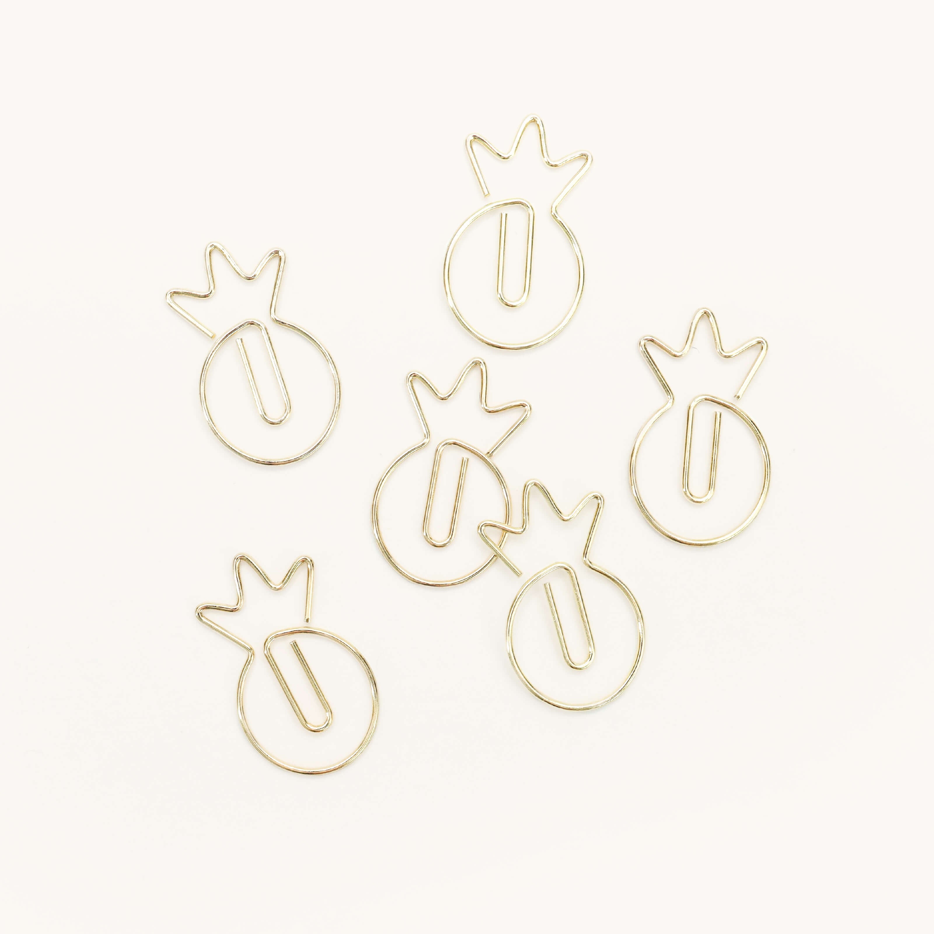 Six Simplified Paper Clips - Pineapples, in gold metal, are displayed on a white background.