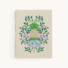 Decorative notebook with floral and key design on a beige background