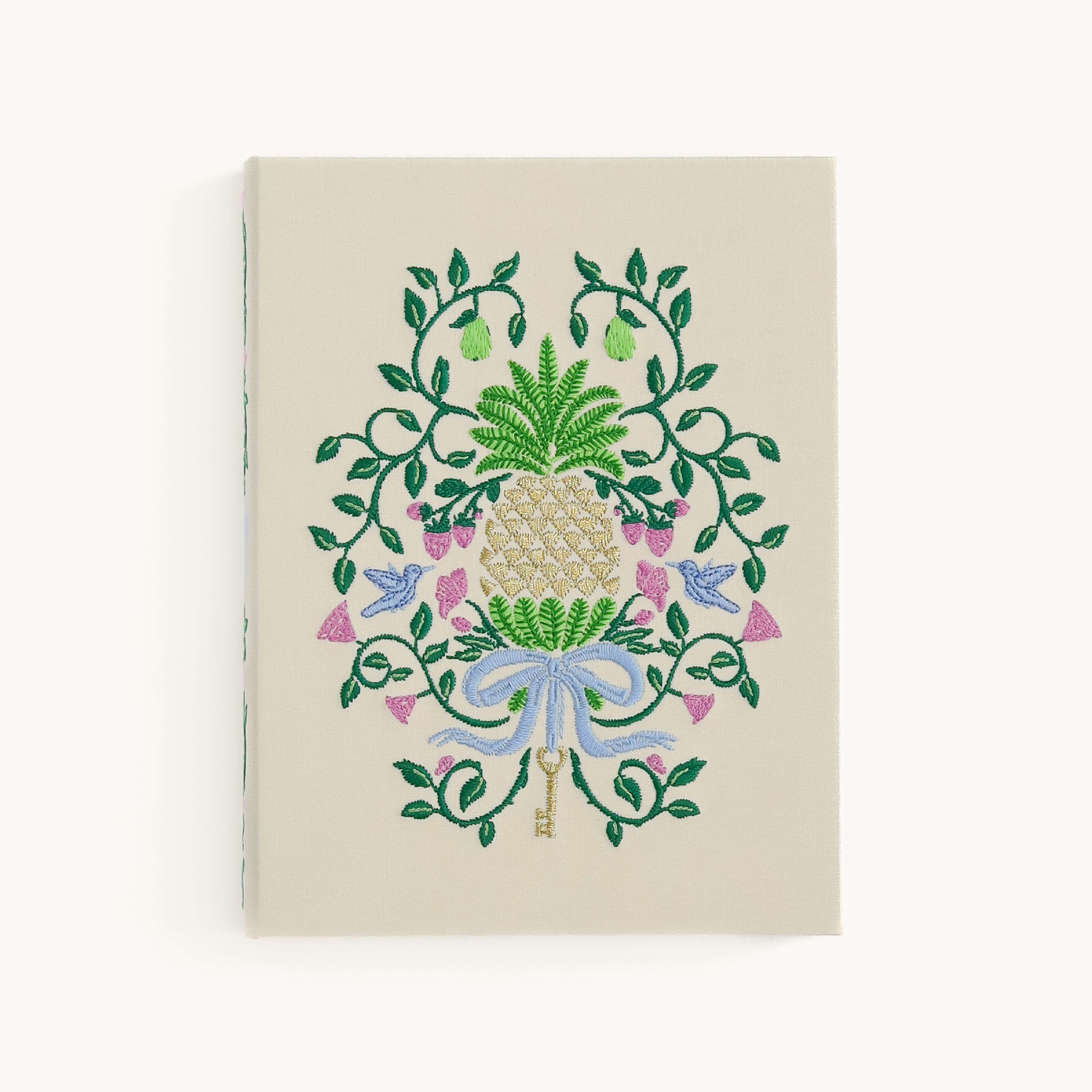 Decorative notebook with floral and key design on a beige background