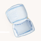 Open blue floral toiletry case with structured compartments by Simplified by Emily Ley