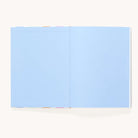 The Simplified Linen Journal - Back and Forth features light blue blank pages with multicolored divider tabs, shown open against a plain background—perfect for deepening connection as a back-and-forth journal.
