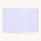 The Simplified Linen Journal - Celestial features a lay-flat linen hardcover and completely blank white pages, shown open against a plain, light background.