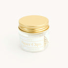 A clear glass jar with a gold screw-on lid contains durable metal heart-shaped paper clips. The label reads “Paper Clips - Heart, Simplified® by Emily Ley, 12 Brass Clips.”.