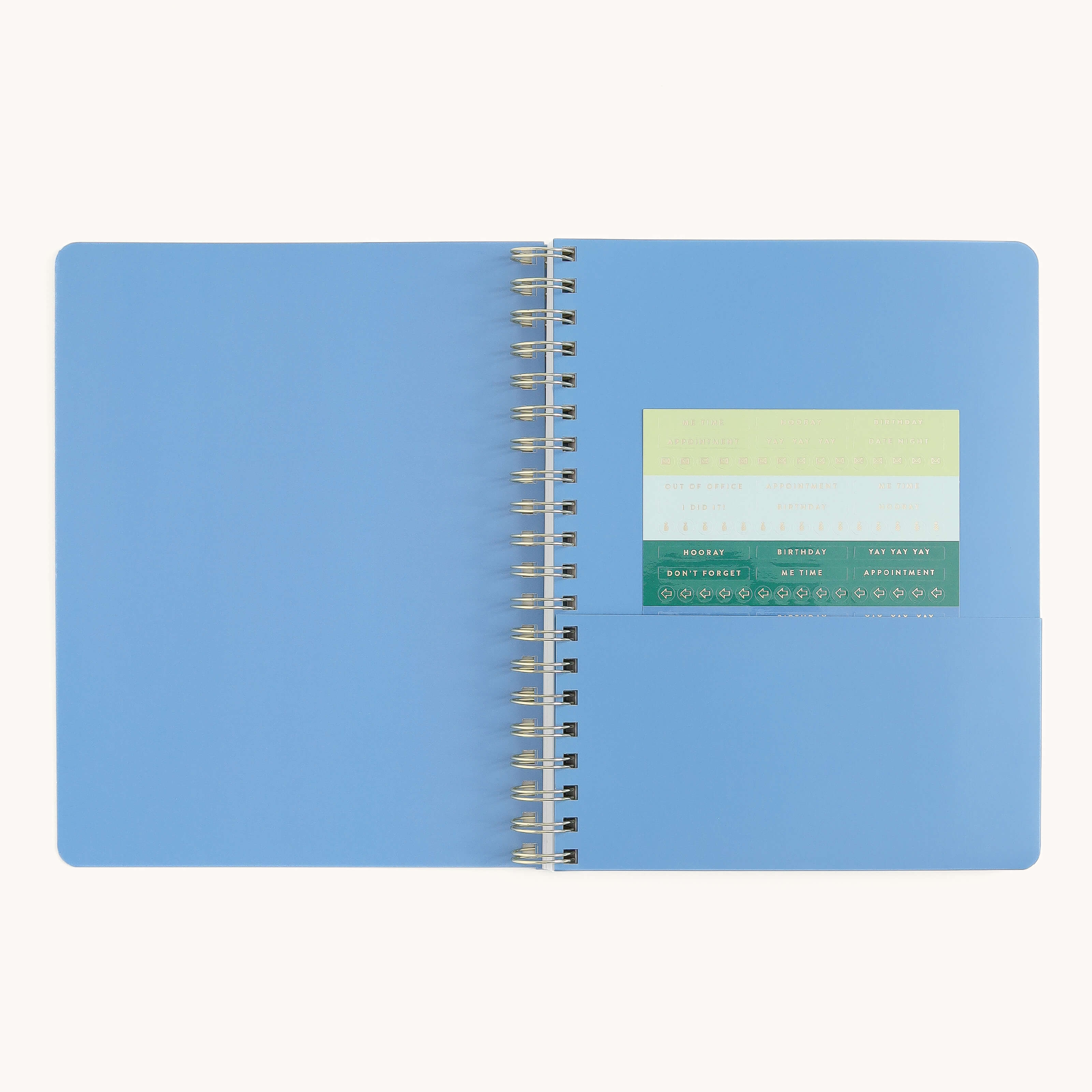 Large softcover weekly planner interior with storage pocket and sticker page for organizing notes, reminders, and weekly plans