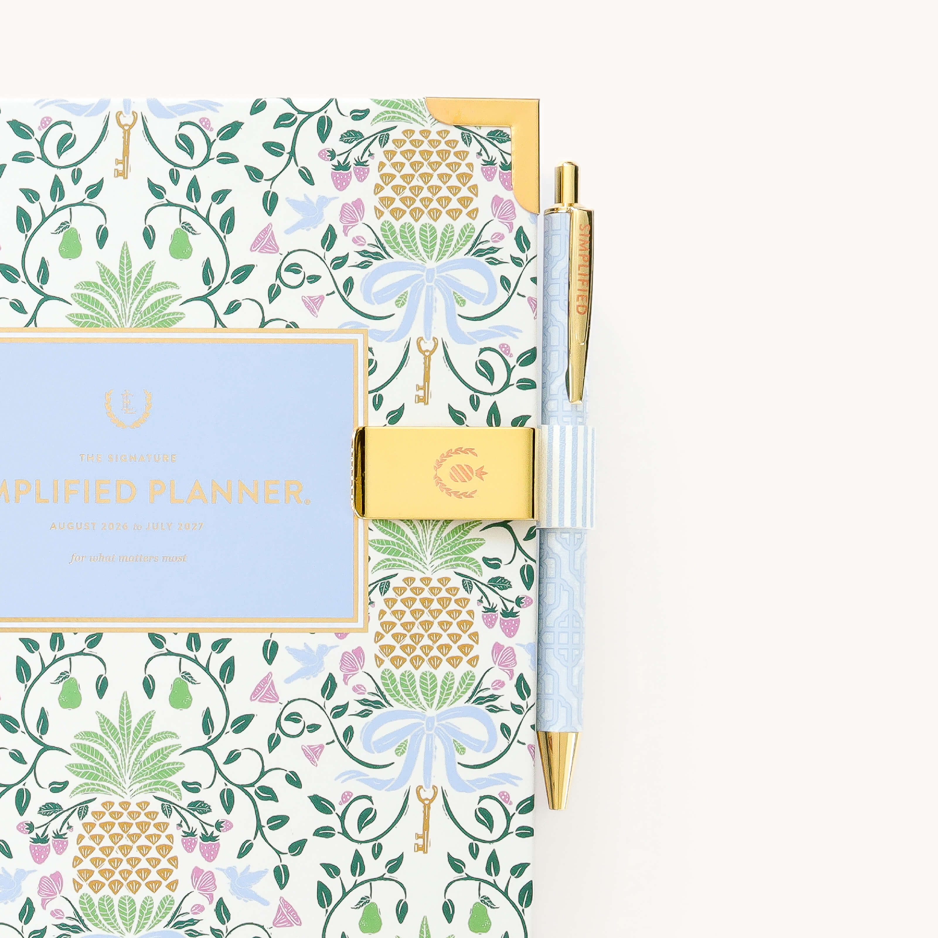 Brass pen clip attached to planner with Blue Pinstripe design for keeping pens accessible and neatly stored on the go