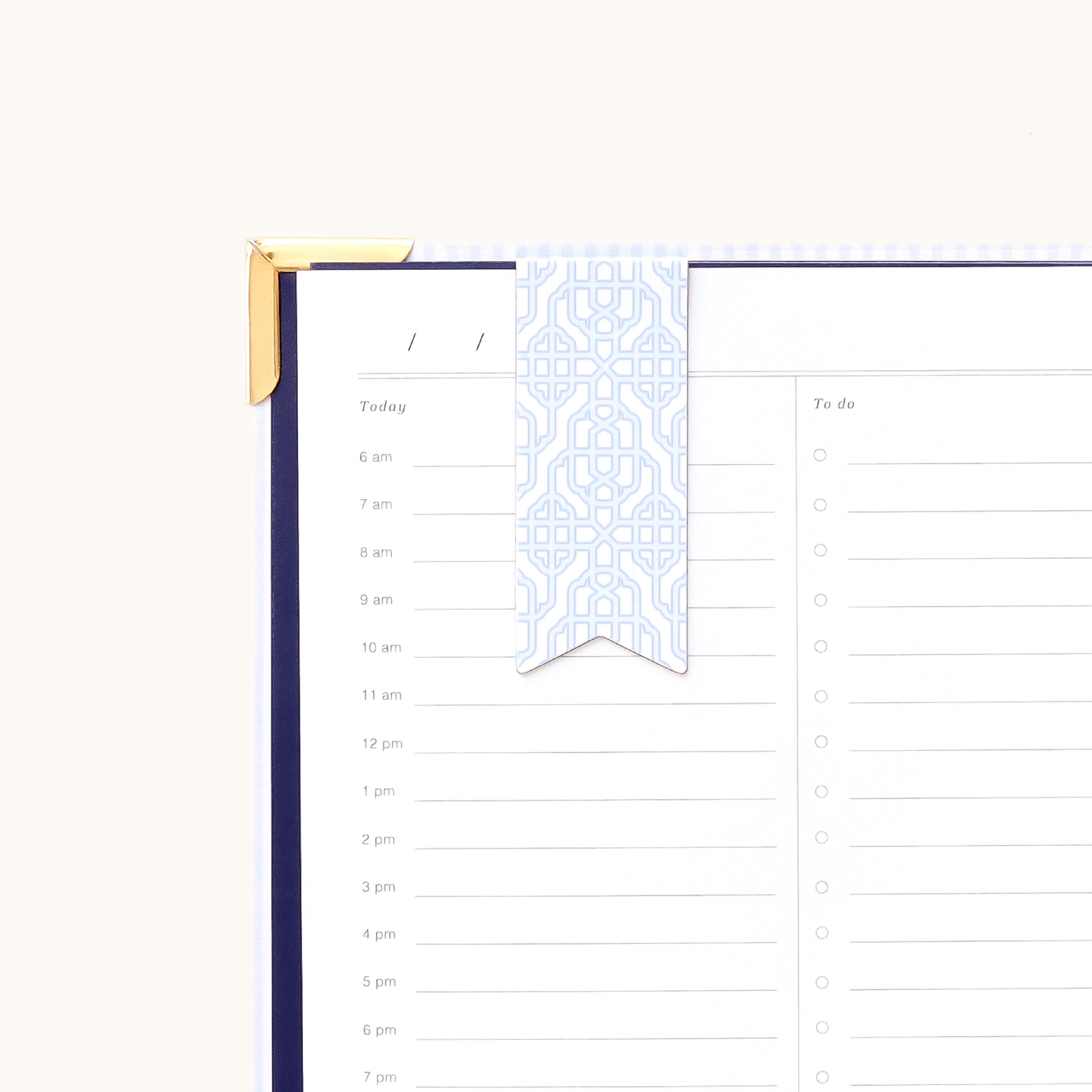 Magnetic page marker clipped onto planner page with Carolina Trellis design for easily marking your place and organizing daily plans
