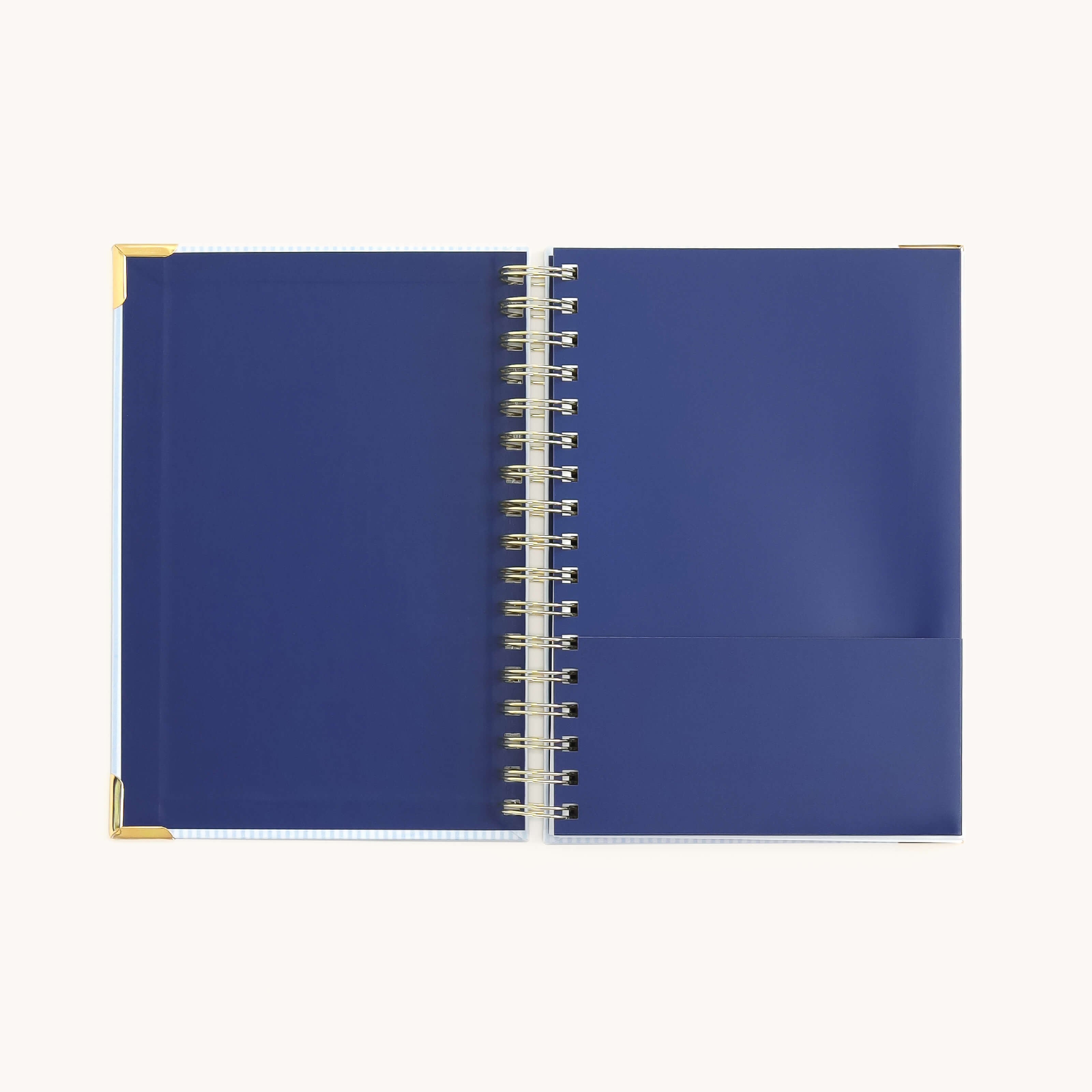 spiral daily planner interior with storage pocket for organizing notes, papers, and planning essentials