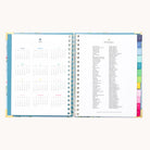 The 2026 Spiral Weekly Simplified Planner - Faraway Land by Simplified features a weekly layout with a yearly calendar and holiday list, plus colored tab dividers along the edge for easy organization.